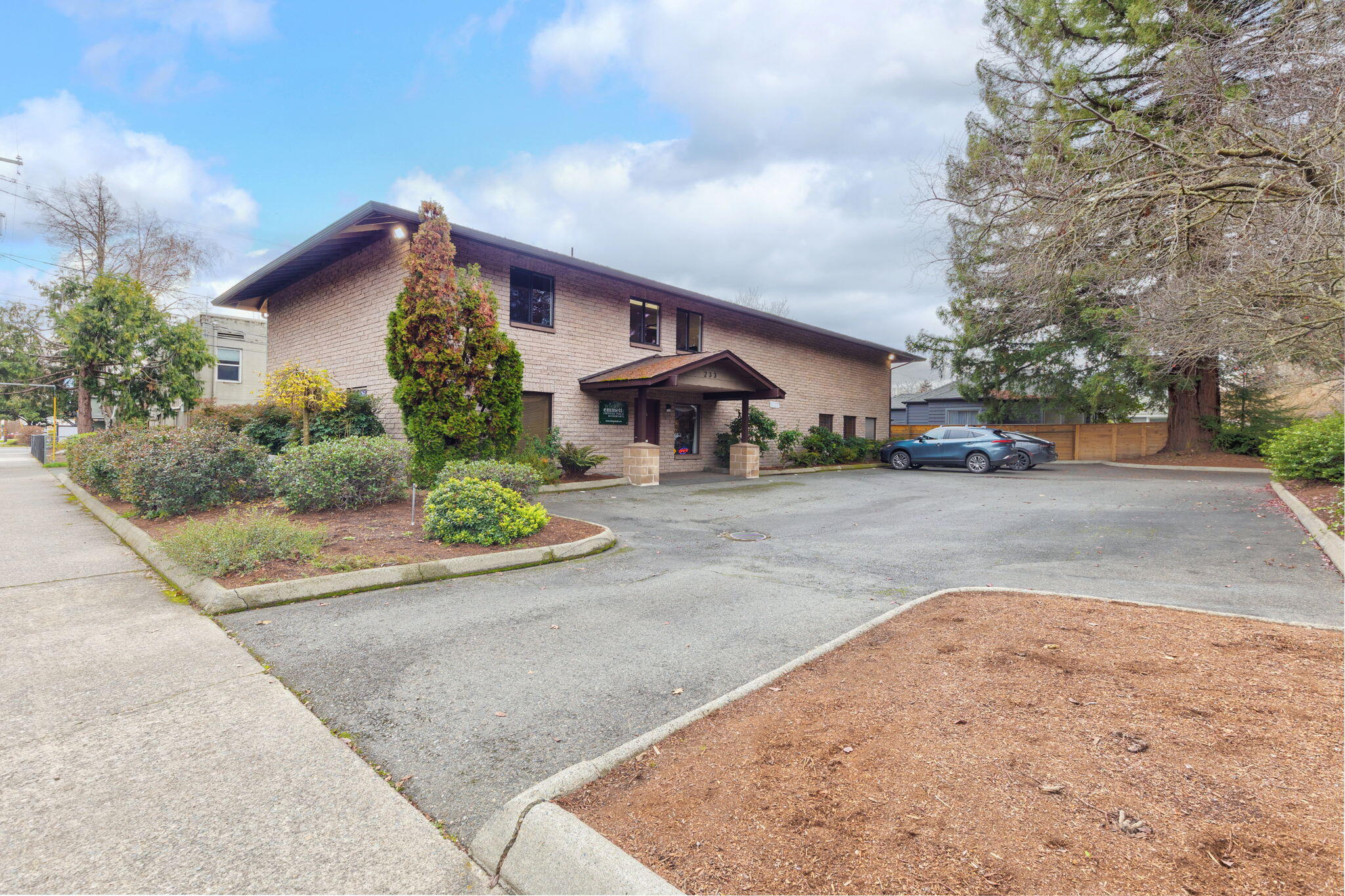 Prime 1031 Exchange Opportunity! Discover a solid investment in the heart of the Grants Pass Business District. This impeccably maintained 4,800 sq/ft office building sits prominently on a large corner lot & offers 13 parking spaces with additional parking nearby. The modern, efficient interior has been designed to accommodate a variety of professional uses, contributing to its strong track record of long-term occupancy by quality tenants. A common vestibule provides separate access to the upper & lower levels, complemented by an exterior staircase for added convenience. The ground floor features a private lobby, multiple well-appointed private & shared offices, a restroom, & storage. The upper level includes additional office suites, restroom facilities, a lunchroom, & a generous storage area. With its flexible layout, exceptional condition, & unbeatable location, this property delivers reliable income with low maintenance demands. Existing leases make this a turnkey investment.
