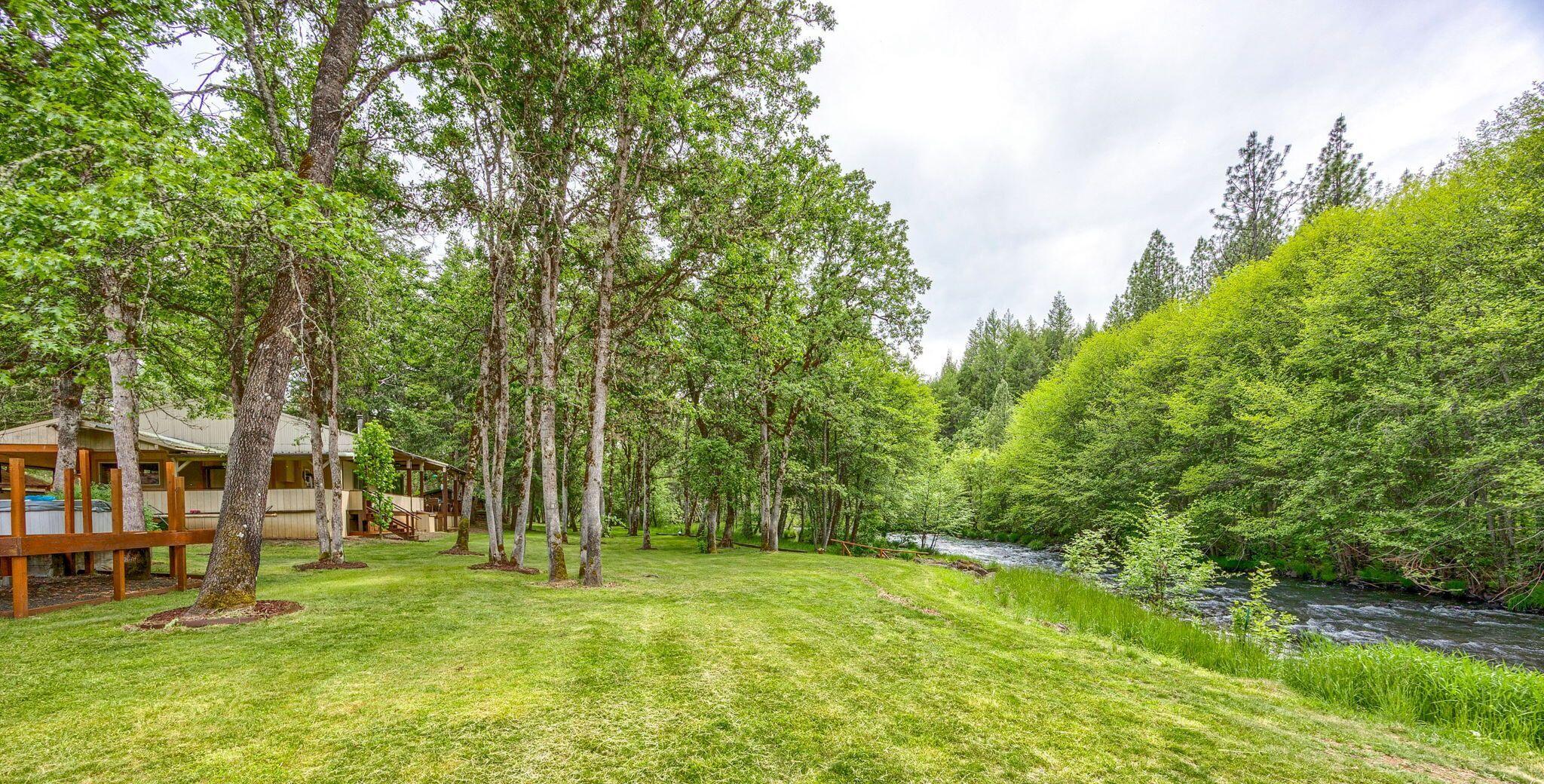 Oregon Dream Property nestled along year-round Big Butte Creek! Beautifully wooded setting with rolling lawns to the water's edge, meandering walkways, enchanted oasis, river rock firepit, separate deck with hot tub, horse shoe pit and much more.  Approximately 600ft of creek frontage per Seller (essential Salmon habitat) & 1972 built manufactured home, 2-bedrooms, 2-baths, complete with wrap around deck and super structure metal roof. Almost 800sf separate workshop/carport with 100amp service and fully insulated & finished 900sf studio built in 2018 with 9ft ceilings, T&G Pine floors, sliding barn style door, metal roof and 24 solar panels that provide economical year-round power. This property has been well maintained and features 403 acres of BLM to the East and end of the lane privacy. A true gem and rare opportunity to own a little piece of paradise located at the water's edge.  You must tour to truly see what this incredible property has to offer.