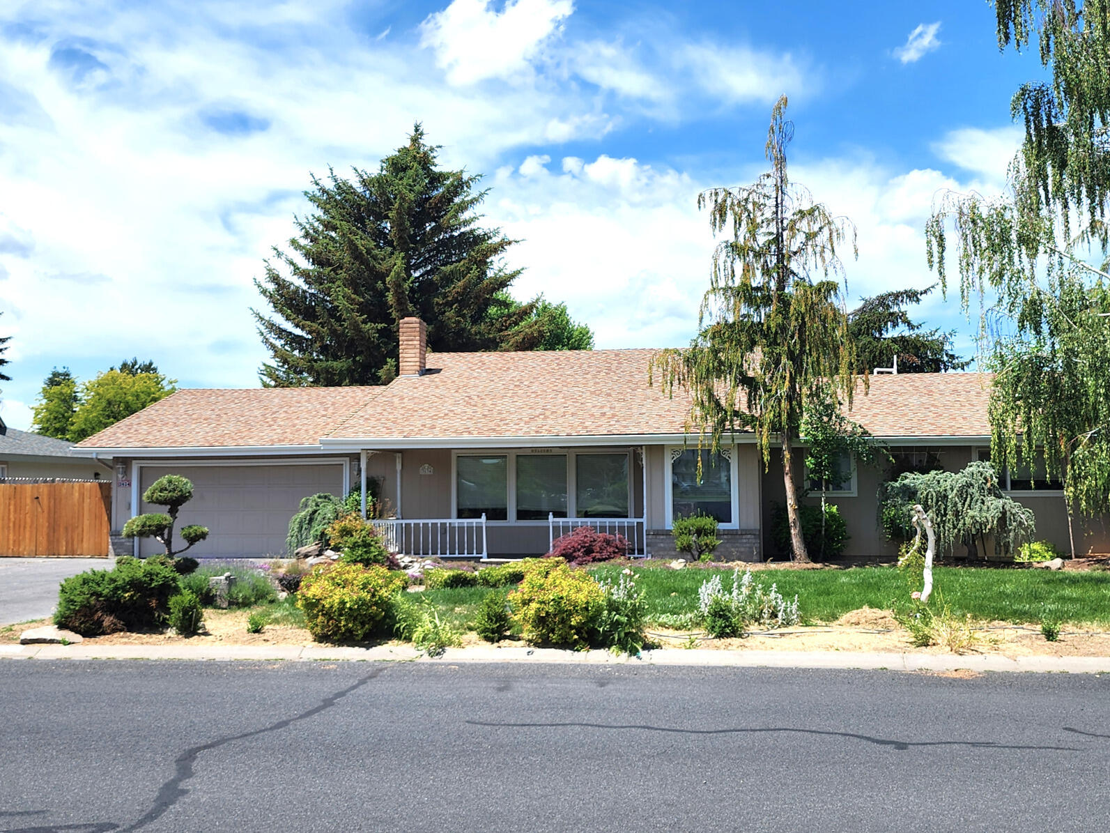 Attention VA Buyers - Low-interest VA Assumable Loan possibility!  Lovely Covered Front Porch, & Tiled Entry to the Main Living areas. This 2036sf Spacious Home has an Open Floor Plan, with the Kitchen opening to both the Dining area, and Family Room. Newer Vinyl Plank Flooring. The Kitchen has ample Cabinetry, and a large Breakfast Bar providing both Storage & Seating. Both the Family & Utility rooms have Sliding Doors opening to the Backyard with both large Patio and Deck. Gas Fireplaces and Built-in Cabinets are in both Living and Family rooms, and the home is equipped with a Central Vac system, Surround Sound in the Family Room, Vinyl Windows, Gas Heat, and Air Conditioning. Bedroom #3 has a built-in Desk, and the Primary Bathroom has a step-in Shower. The Garage features a Workbench, Sink, Storage in the ceiling, and a new Water Heater.  Large Lot with Gated RV Parking option!