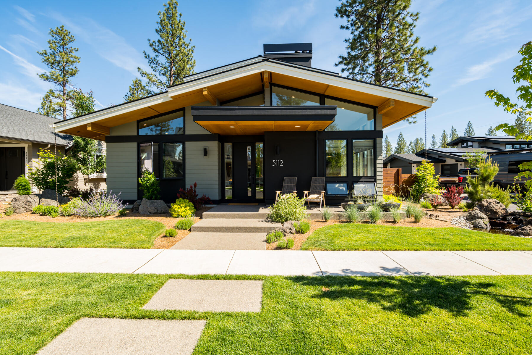 Absolutely stunning custom contemporary home in NW Bend's Discovery West. Carefully crafted by Leader Homes, this home features an open great room with a cozy gas fireplace, vaulted ceilings with exposed beams, and expansive windows that flood the space with natural light. The chef's island kitchen impresses with wide plank hardwood floors, quartz counters, high-end appliances, and a beautiful dining area that is ideal for entertaining. Retreat to the main level primary suite with vaulted ceilings, spacious walk in closet and private bath complete with double vanity, tiled shower, plus much more. The second level offers a large bonus room with its own gas fireplace, two generous bedrooms, and a full bath. Additional features include a private study and an alley access 3 car garage. Thoughtfully designed, fenced side yard with a large patio, hot tub, and low-maintenance landscaping. Close to schools, parks, trails, shopping, and dining. Schedule your private showing today.