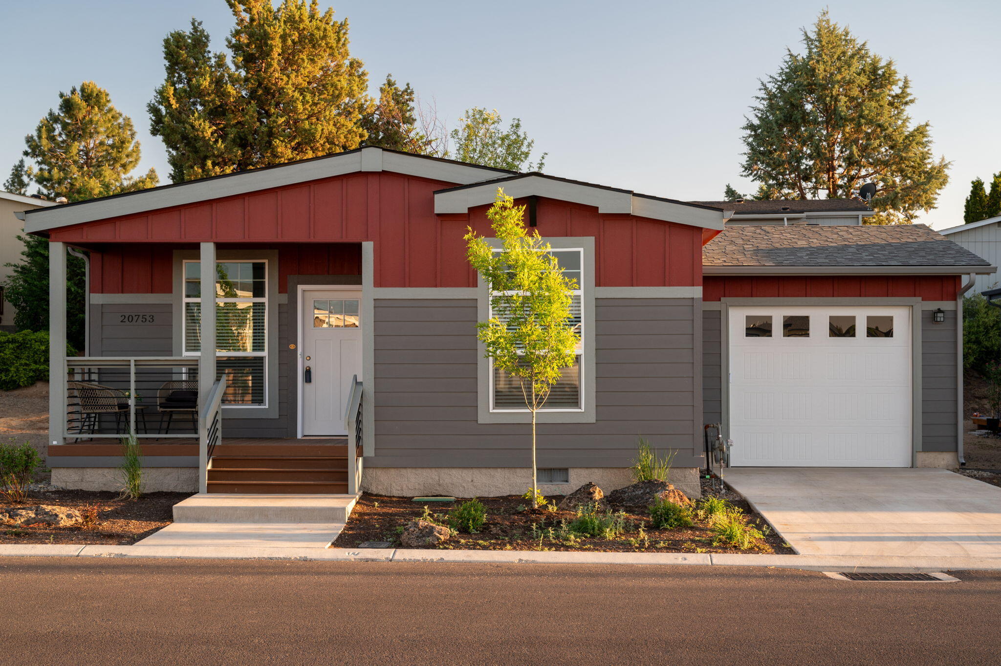 Featuring striking 9' ceilings, this Summit Loop model radiates style and convenience. Central A/C ensures a pleasant atmosphere year-round. The heart of the home showcases a premium stainless steel appliance package with a charming farmhouse sink. Gray overhead and base cabinets with soft-close drawer guides and hinges provide a seamless blend of elegance and practicality. This Energy Star-rated home promotes energy efficiency and ease of use. The kitchen and bathrooms are complimented with granite countertops that deliver a sophisticated touch. The primary bath features a stunning Polar Frost Duma wall shower, creating a spa-like retreat. Additional highlights include a paddle fan in the living room for added comfort and stylish pendant lights above the kitchen island, perfect for entertaining. This residence is designed for those who appreciate contemporary living, making it a true sanctuary that combines comfort, style, and efficiency, all in one inviting package.