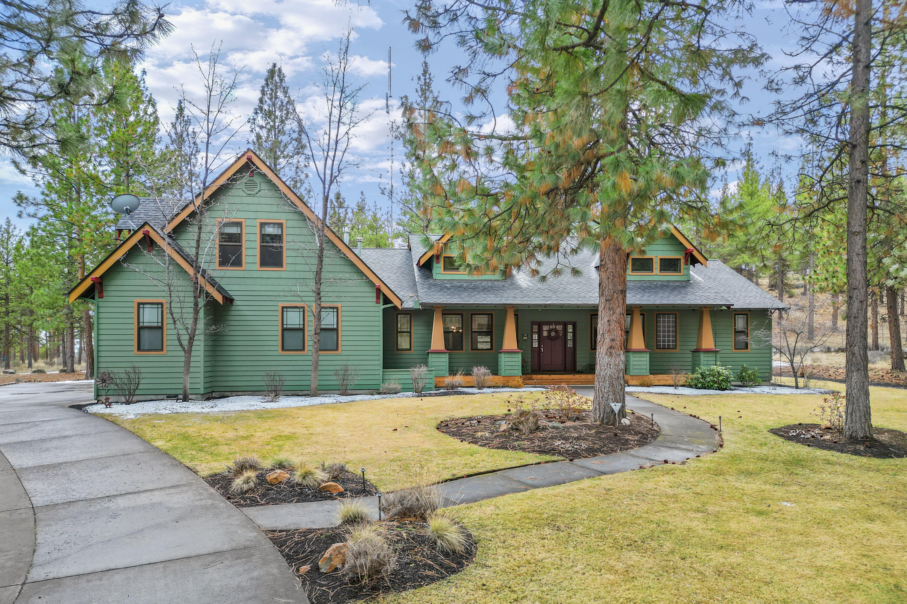 This sensational Awbrey Butte home is situated on a lovely cul-de-sac. It boasts a flat, beautifully groomed yard on over a half an acre with towering, old growth Ponderosa pines. The kitchen was recently remodeled with exquisite high-end finishes and is an entertainers' dream with a massive quartz island and seating for the whole family. The four-bedroom home is mainly one level living with a bonus room, bathroom & office over the garage. The Primary Suite is situated opposite the three downstairs bedrooms for maximum privacy with French doors leading to a patio with hot tub, ideal for unwinding after a long day. The oversized two-car garage with workbench is perfect for hobbyists and offers plenty of storage.  There is also a small, charming shed that mimics the home, ideal for gardening or a playhouse. Experience the perfect balance of peaceful living with convenient access to shopping, dining and outdoor adventures. Schedule a tour today and discover the lifestyle that awaits you!