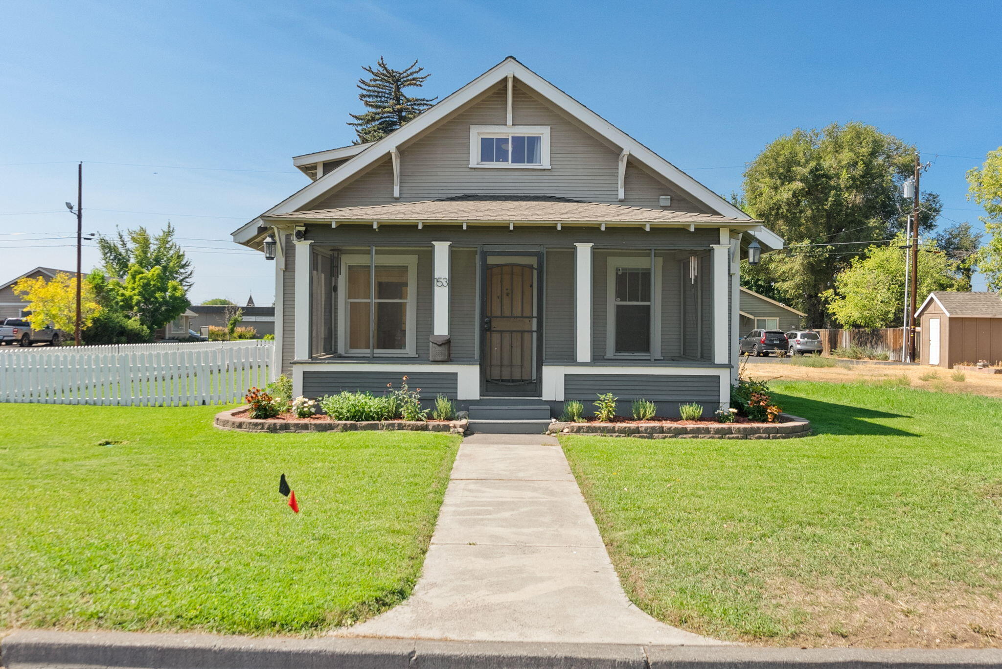 This thoughtfully updated 4-bed, 1-bath historical home sits on a corner lot in the heart of Redmond's Urban Renewal District and offers rare commercial zoning flexibility. Blending classic charm with modern upgrades, it features marble kitchen counters, a brand-new bathroom, hardwood floors, energy-efficient heating & cooling, a gas fireplace, tankless hot water heater and abundant natural light from the ample windows. Relax on the screened front porch, enjoy the fenced side yard, and take advantage of the spacious attached garage on a prominent corner lot. Wired for both a hot tub and RV. Located just moments from Hwy 97, a short walk to downtown shops, and popular food carts like General Duffy's & Blacksmith Public House. Another short walk lands you in the Dry Canyon for outdoor activities .Whether you're looking to live, work, or invest—this unique property offers unlimited potential in a highly desirable location.