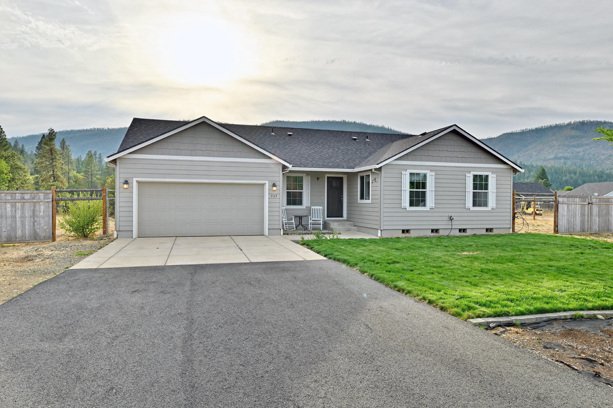 Recent 17k price reduction! Welcome to your dream home in one of Cave Junction's most desirable gated communities! This 2021-built Hayden Home offers 4 spacious bedrooms, 2 full baths, and 1628 sq ft of thoughtfully designed living space on just under an acre of flat usable land. Step inside to vaulted ceilings, a split floorplan ideal for privacy, and a dedicated office space perfect for remote work or study. The open-concept kitchen features a large island & built-in microwave, modern finishes, and flows seamlessly into the main living area — perfect for entertaining. The primary suite includes a walk-in closet and a private bath for your own personal retreat. Enjoy outdoor living with timed sprinkler systems in both the front and backyard and take in the sweeping views of the Illinois Valley. Don't miss this rare opportunity to own a modern home with space, views, and access to some of Southern Oregon's finest natural beauty!