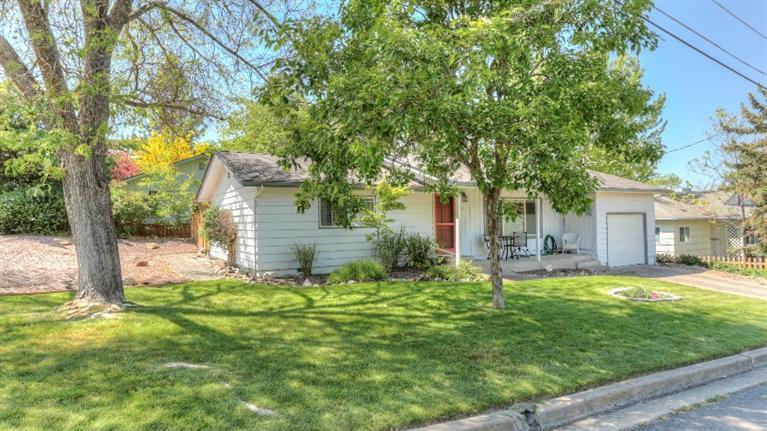 Absolutely darling, two bedroom cottage in a very sought after neighborhood. With hardwood floors throughout the primary living areas, this home is super charming. Nicely remodeled kitchen features tiled countertops and backsplash and lots of cabinets. The light filled dining room is adjacent to the kitchen and has French Door access to a newer deck and private backyard. Two roomy bedrooms, full bathroom, interior laundry room and attached garage. The home has a double paned windows, newer roof, newer fence on two sides, has been freshly painted and well maintained over the years.