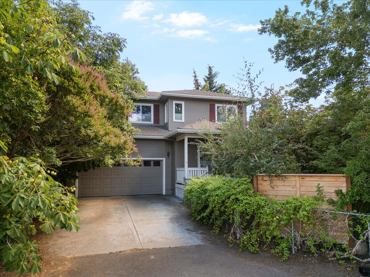 Get inside this lovely home that is tucked away from the Main Street the yard is all fenced. The home features 2 bedrooms plus a bonus room, 9 ft ceilings and beautiful Acacia hardwood floors in the living room by the gas fireplace & brick mantel. The open floor plan really shows off the kitchen with granite counters & walk in pantry. The primary bedroom is on the main level with ensuite tub/shower combo & a walk in closet that has access to private back yard. Upstairs is 1 additional bedroom plus the bonus room. The backyard is larger than most in this subdivision and treed with a great covered stone tiled patio with fan & light.