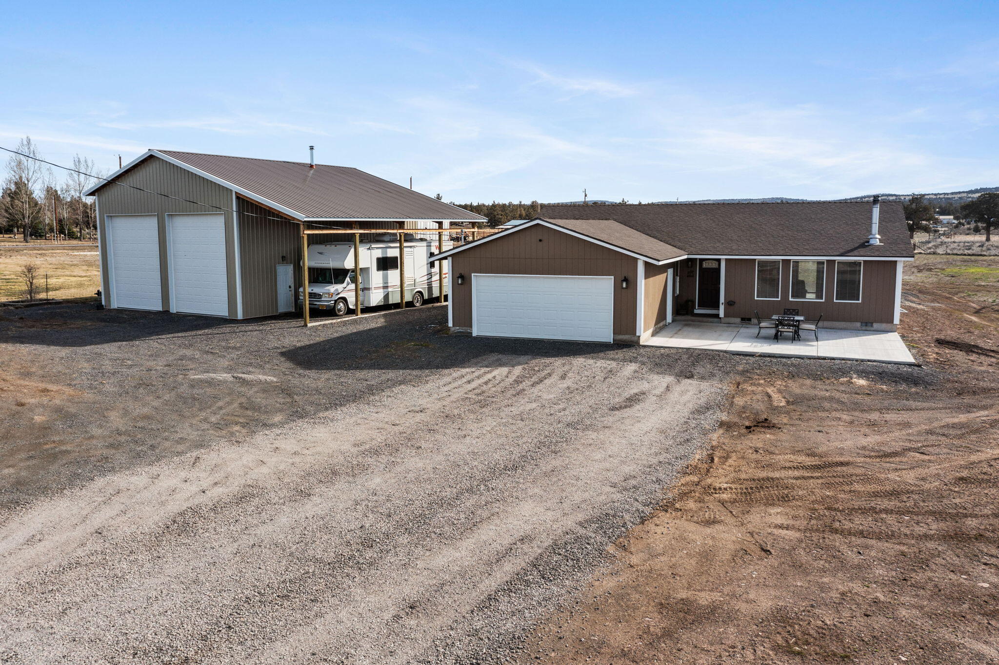 Cute home in the desirable Prineville Lake Acres! This secluded 3-bedroom, 2-bathroom single-level retreat sits on 2.14 acres, offering stunning mountain views and privacy. The open floor plan features laminate floors and a spacious kitchen with an island, perfect for family gatherings. Enjoy cozy evenings by the woodstove or unwind in the hot tub on expansive front and back patios. A 40x30 shop with a lean-to and loft provides ample space for hobbies or storage. Fully fenced with a gated entry ensures peace of mind. With access to public lands right around the corner, outdoor adventures are just moments away. This charming property is ideal for those seeking a tranquil lifestyle with room to grow. Don't miss your chance to own this slice of paradise!
