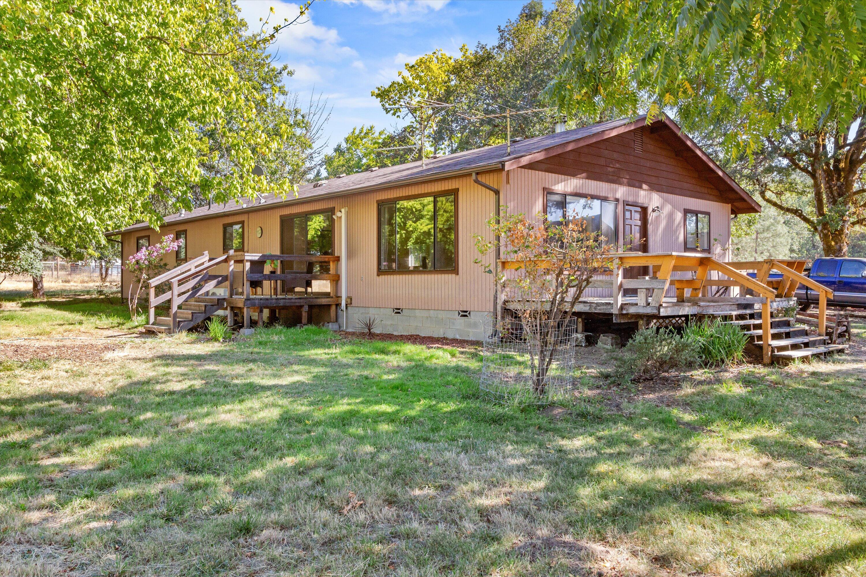 This rare and incredible opportunity to own over 15 acres of flat and usable land in Hugo does not come up for sale often! Make your move on this home with over 2000 sqft of living space on over 15 acres of prime land! Brand new roof just installed! Featuring a home with 3 bedrooms and 1 bathroom and a large barn, private driveway, and plenty of room for animals, family gatherings and so much more! The property is cross fenced for horses or livestock, also has a carport for storage. There is also a small creek at the back of the property. Don't wait to tour this home, make an appt today!
