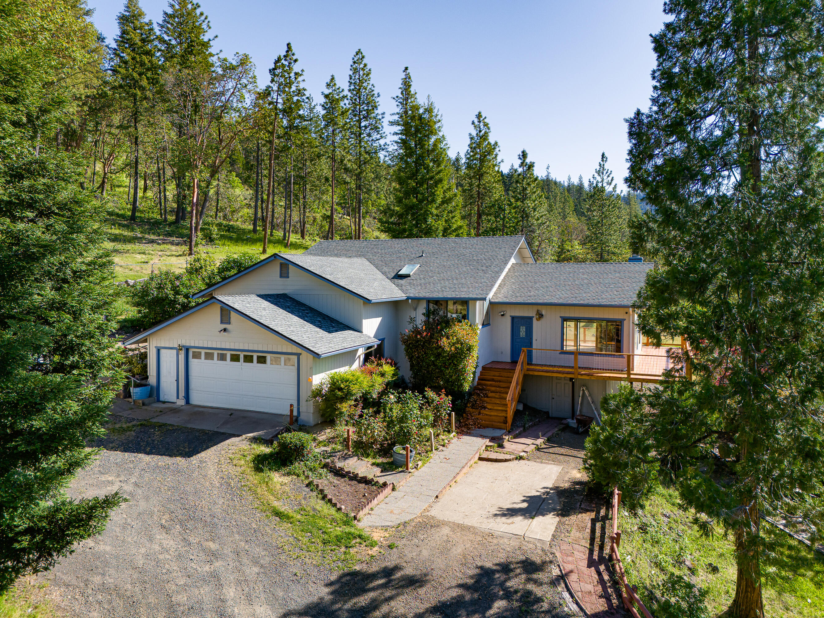 Escape to your private sanctuary in the Cascade Mountain foothills of Southern Oregon, where hills cradle a breathtaking view of Lost Creek Lake—the Rogue Valley's premier recreation jewel. On 9 manicured acres, this 1994 built split-level gem (1,992 sq ft) blends rustic charm with modern comfort. A new expansive deck frames sunrise lake reflections and sunset mountain glows. Inside, warm oak floors flow through open living spaces, heated by a Lopi woodstove insert. Fresh carpets adorn three bedrooms; the master suite boasts panoramic lake vistas. The island kitchen, with new luxury vinyl tile, opens to the living room—ideal for gatherings. Outside: a 24x30 insulated shop/garage, gated driveway, and covered RV carport with 110-amp service. The lake boat launch is just minutes away; Crater Lake is 30 minutes. This $625,000 lakeside retreat offers peace, play, and endless horizons. Your dream awaits!