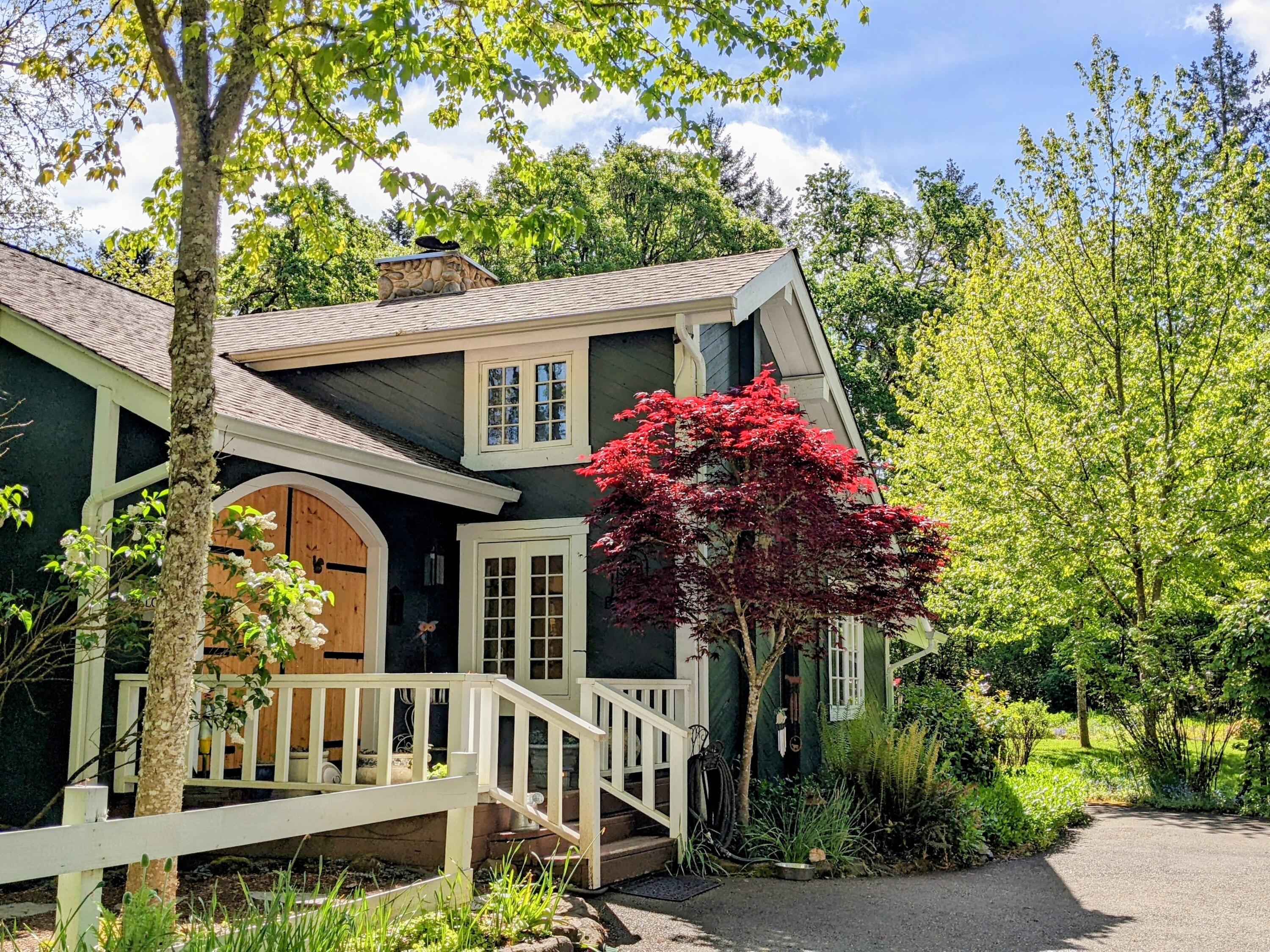 Back on the Market at No Fault of the Sellers or the House!
Peaceful Retreat on 7+ Acres in Meadow View Estates.
Nestled on over seven acres, this nearly 3,000± sq ft home offers privacy, charm, and beautiful views of trees and pastureland. A tree-lined driveway leads to the home, setting the tone for the serene lifestyle that awaits. Step inside to a warm, cabin-style interior featuring a central stone fireplace, rich wood accents, and expansive windows that frame the natural surroundings.

The main level includes 2 bedrooms, 1 bath, and a cozy sitting area—perfect for reading or enjoying quiet moments. Upstairs, the oversized primary suite features a spacious bathroom, an inviting sitting room, and beautiful new balcony to enjoy your view, creating a private sanctuary within the home. A charming loft offers a flexible bonus space—whether as a cozy crafting nook or a dream haven.

The open kitchen, complete with ample cabinetry, a central island, and abundant natural light.