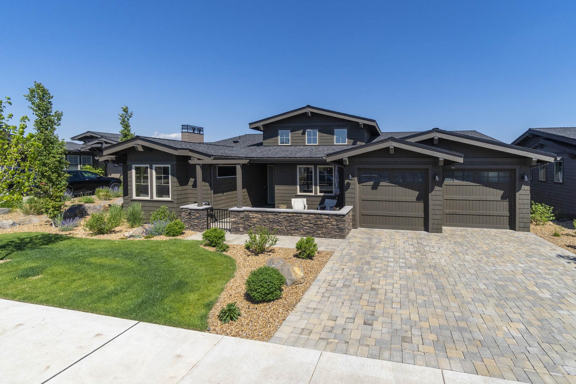 Welcome to luxury living in Tetherow with incredible views and sophisticated finishes. As you walk through the front door, you're immediately met with soaring ceilings and an open floorplan with expansive windows which perfectly frames the snow capped mountains and Tetherow golf course. This home has great main level living with 3 suites and an office/den on the first floor, and 2 additional bedrooms and extra family/media room with barn door downstairs. The kitchen does not disappoint and showcases stainless steel Thermador appliances, a neutral and elegant subway tile backsplash, quartz counters and a generously sized island
with granite countertops. The main floor includes a spacious great room and dining room with sliders leading out to a corner deck with fireplace for staying warm as the sun goes down over the Cascades. This home truly allows you to take in the incredible views from one of the patios/decks of from the comfort of this classy and well appointed home.