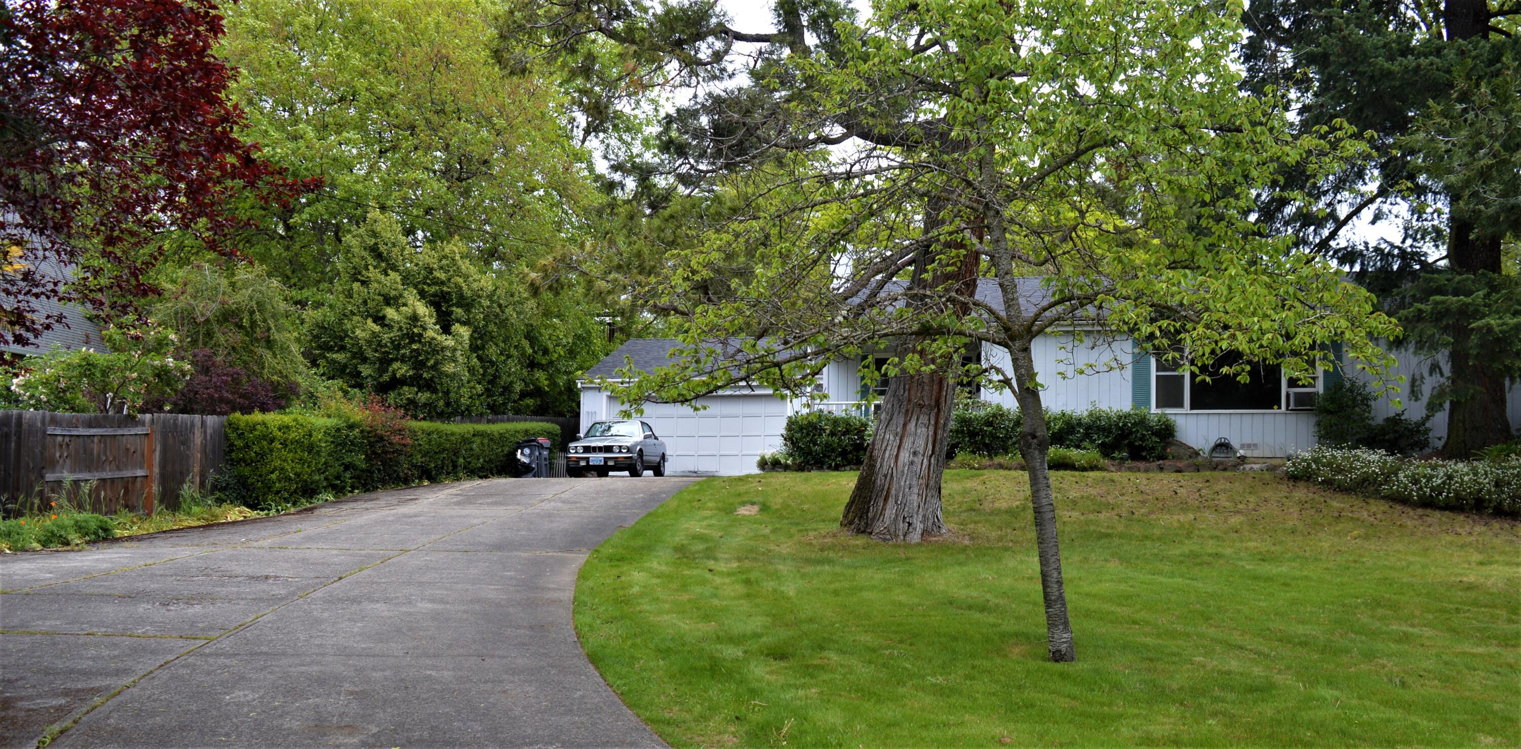 Opportunity Knocks !  A home in East Medford on a Large lot close to shopping, schools, and restaurants.  Home has a 550 S.F. oversized 2 car garage.  Plenty of room for parking, and a well laid out backyard for entertaining.   Interior has a patio sunroom, 3 bedrooms, and some hardwood flooring underneath the carpet.   This lot has room for expansion too.