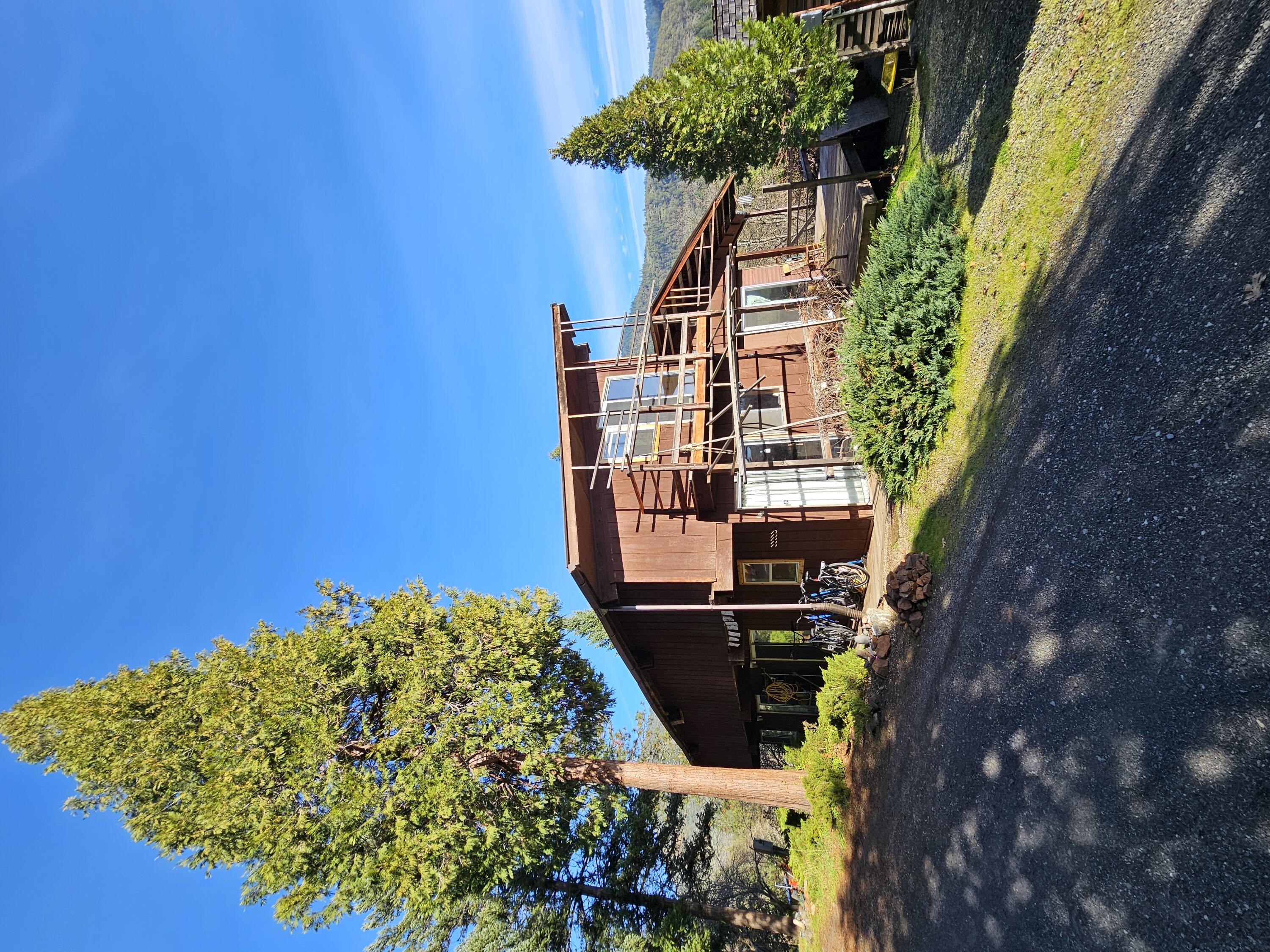 Here is your chance to secure beautiful acreage in the Grants Pass country side. The home is tucked at the end of the drive way for lots of privacy. Multiple improvements have been made to the property including several well-built cabins for guests. A new 9x6 cedar wood fire sauna. 60 gallon per minute well with dual water softeners! The home was remodeled nicely! Beautiful views of the mountains and valleys from your front porch. Drivable trails that take you all over the large acreage property with many different paths to walk. Several green houses perfect for off the grid living. Come see it today before its gone!