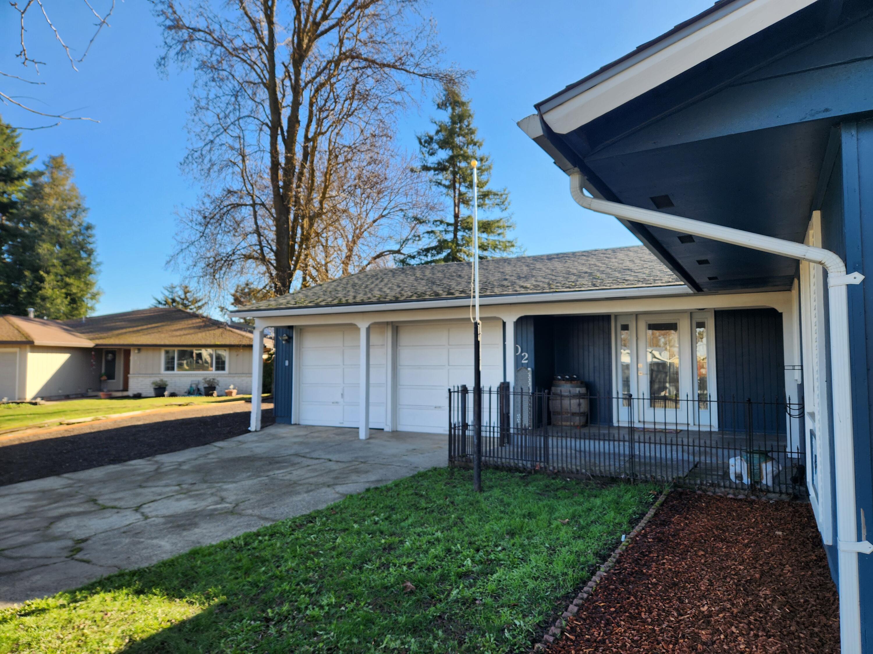 Located in a quiet cul-de-sac is a beautifully remodeled, single-level ranch-style home in Northwest Medford. Spanning 1,586 square feet, this 3-bedroom, 2-bathroom residence offers modern updates and versatile outdoor features. The kitchen features updated cabinetry, ample counter space, and stainless-steel appliances, including the refrigerator. An open floor plan includes a fireplace, hardwood laminate flooring throughout main living spaces, with fresh carpet in bedrooms. The roof, HVAC system, doors and lighting have been updated within the past nine years. The 0.20-acre lot features a fully fenced, level backyard with raised garden beds, a greenhouse, and a storage shed.