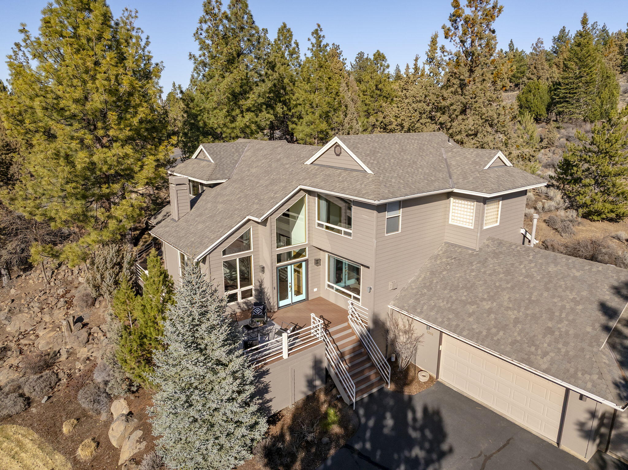 Offering an unbeatable private location at the end of a cul de sac within the desirable gated community of Awbrey Glen, this spectacularly updated, contemporary home is nestled perfectly on almost an acre lot to take advantage of breathtaking views of the Cascades.  The spacious front yard with mature trees & natural rock outcroppings lead to a wrap-around deck & backyard oasis with hot tub to take advantage of exceptional outdoor privacy.  Expansive & abundant windows frame the scenic mountain vistas in almost every room while flooding the interior with brilliant natural light.  A new kitchen with gorgeous walnut cabinets seamlessly connects to the family room and separate dining area, creating a wonderful setting for cooking & entertaining.  Each bedroom has its own en suite bath including one on the main level.  Easy access to walking trails & golf course amenities!