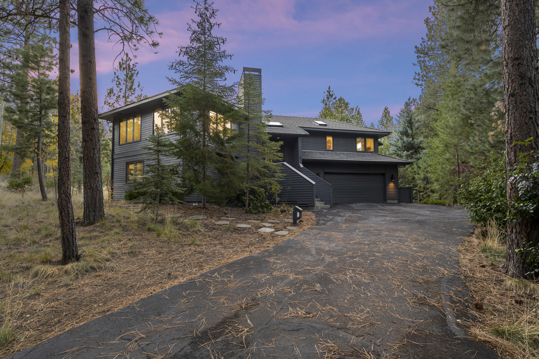 Enjoy a peaceful setting in the pines in one of Bend's most coveted westside neighborhoods. Situated on a private 0.64 acre lot in the secluded Sunrise Village neighborhood, this spacious updated home is light and bright with a comfortable floor plan that has great separation of the primary suite to the guest bedrooms and options for work from home space. Beautiful wood floors, custom built-ins and a central fireplace complement the home, while living extends outdoors with large decks and level lawns surrounded by native vegetation. With ample space for your outdoor gear in the oversized 2-car garage, direct access to the path to private river access and close proximity to the DRT, Phil's Trail complex and National Forest, this is a perfect launching pad for your outdoor adventures! Additional HOA amenities include gated access, pool, hot tub, clubhouse, tennis courts, park and paved paths. Quick access to Mt Bachelor and the High Lakes and only 4 miles to the heart of downtown Bend.