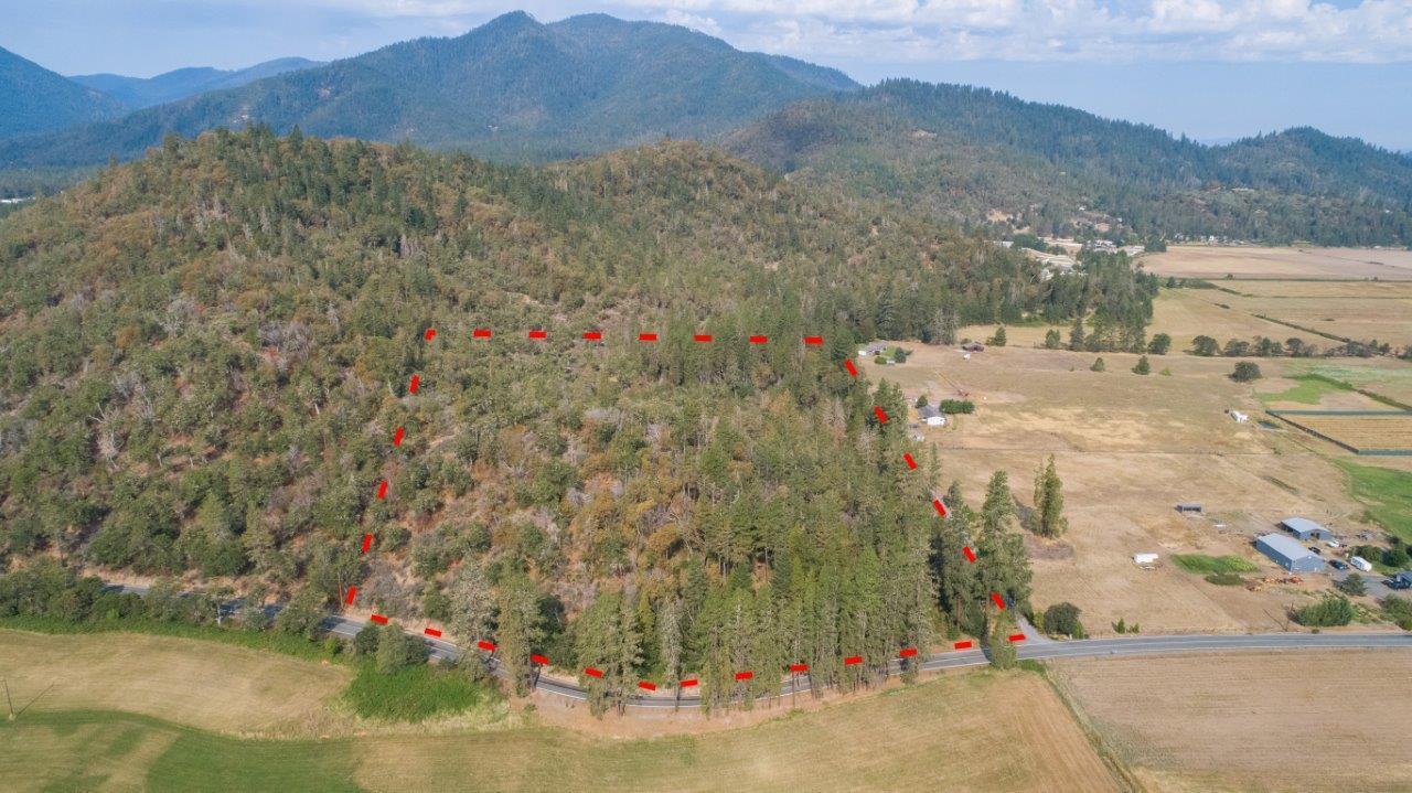 Ready to build?  Or buy now and build later? Lovely wooded land in great location with privacy for future home! Great lot if you are looking for privacy in the country but not too far from town.  Extra bonus: This Raw land is Zoned RR-5 which means it is potentially split-able into 5+acre homesites. Level and rolling land, treed with some lovely homesite areas. Previous owner cleared road and area for potential homesite spot (but now grown over).  Buyer to do own due diligence and verify all uses of property with Josephine County.