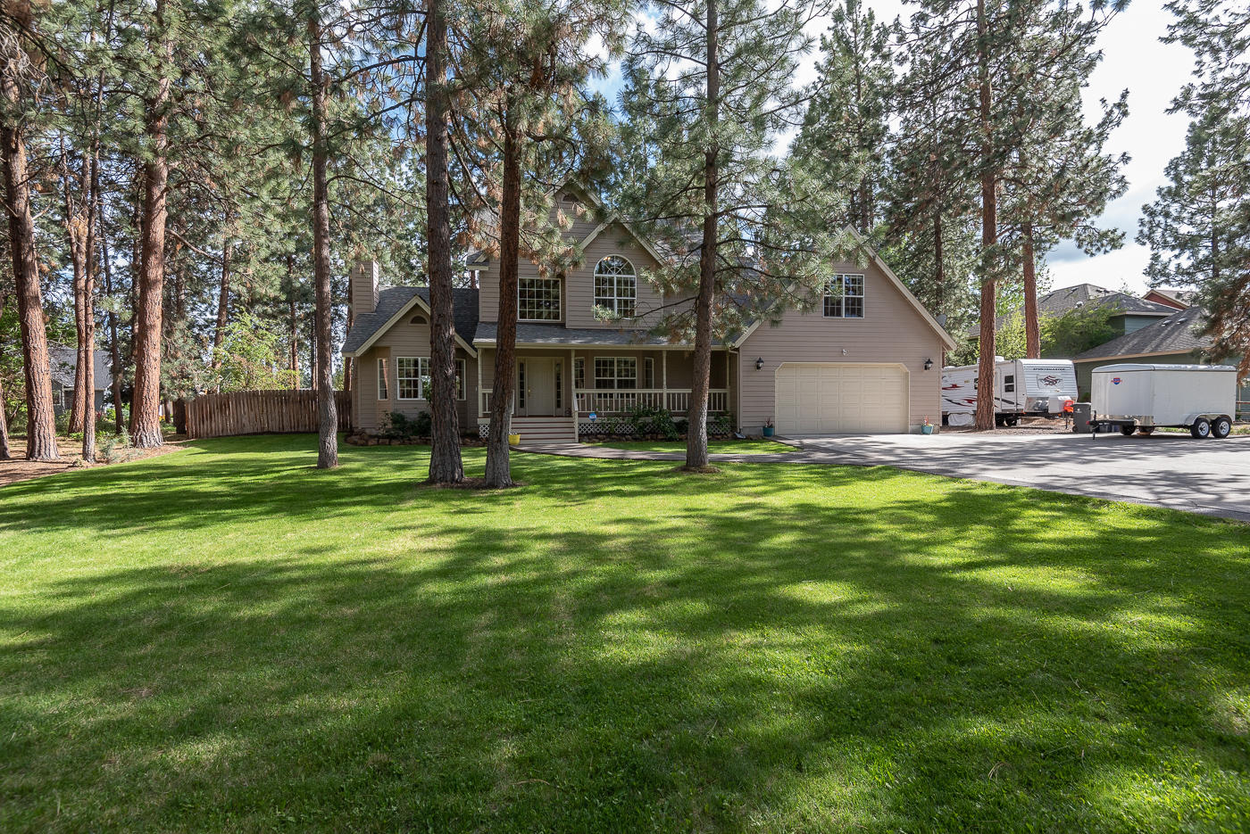 This is special. Live on one generous acre on Hollygrape in Southwest Bend! This traditional home has a sprawling front yard with plenty of parking for cars and an RV. The equally spacious and fenced backyard has two storage sheds, a fire pit (fire pit seating and décor included), horse shoe pit, cornhole, meandering pathway, and a large lovely outdoor deck. It's the perfect place to entertain family and friends and remain socially distant! The home has a bright kitchen with eating space, formal living and dining area, family room, laundry, full bath, and study or additional bedroom on the first floor. There is a separate set of stairs to a large second floor bonus room. Enjoy living in this great neighborhood with none of the CC&R's or association fees.