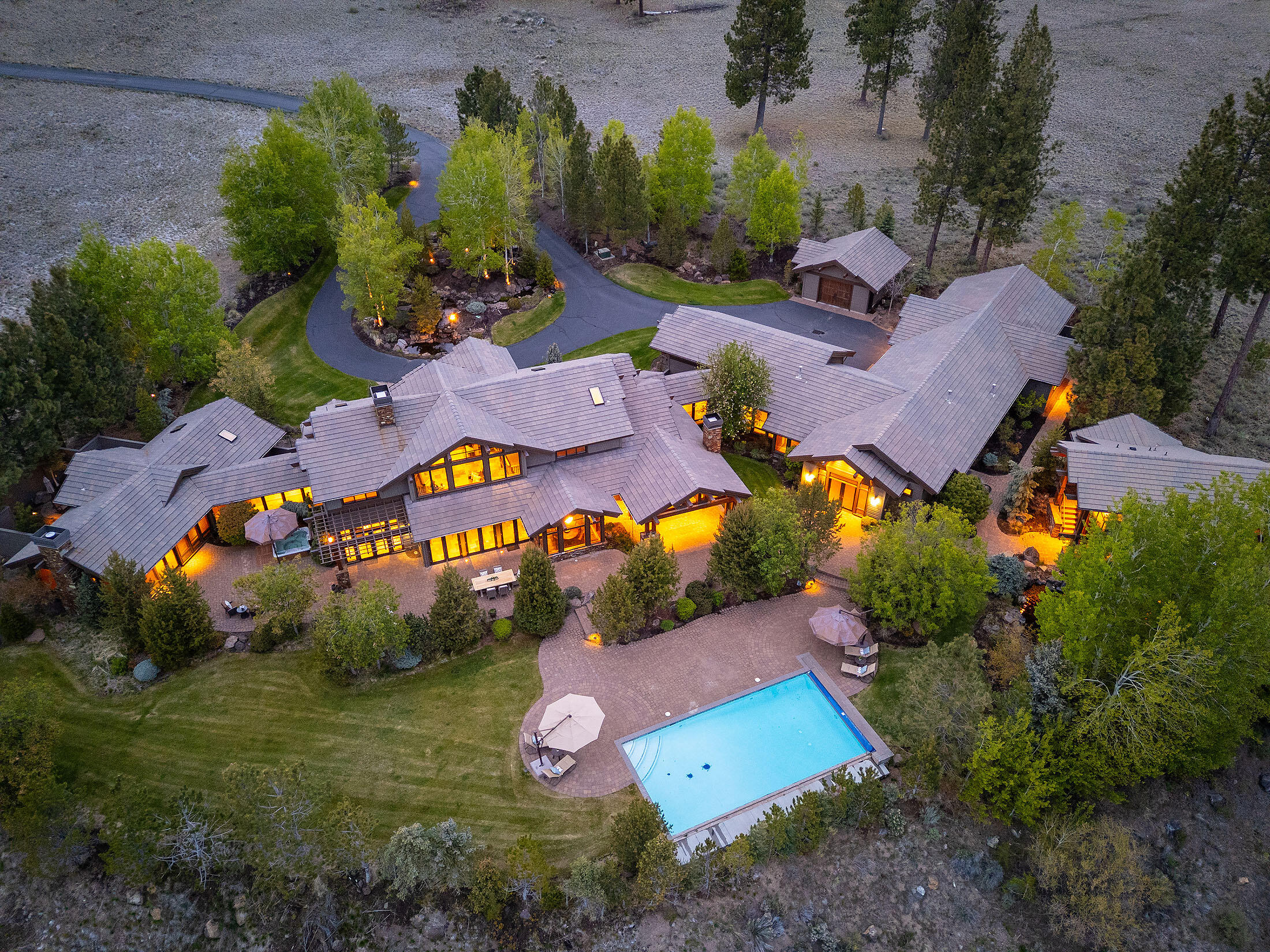 A sanctuary of timeless elegance and mountain serenity, this Norman-built sanctuary rests on 10+ private acres in the exclusive gated Highlands at Broken Top. Every space showcases impeccable craftsmanship—from the impeccable kitchen with veined granite and custom cherry cabinetry to the great room's soaring ceilings and stone fireplace framing breathtaking high desert views. The main-level primary suite offers a serene retreat with fireplace, dual closets, and indulgent ensuite. Entertain in style with a wine cellar, wet bar, library, and home theater, then step outside to a resort-style pool and hot tub. Detached guest house and three heated garages offer additional accommodations in this unparalleled Central Oregon estate.