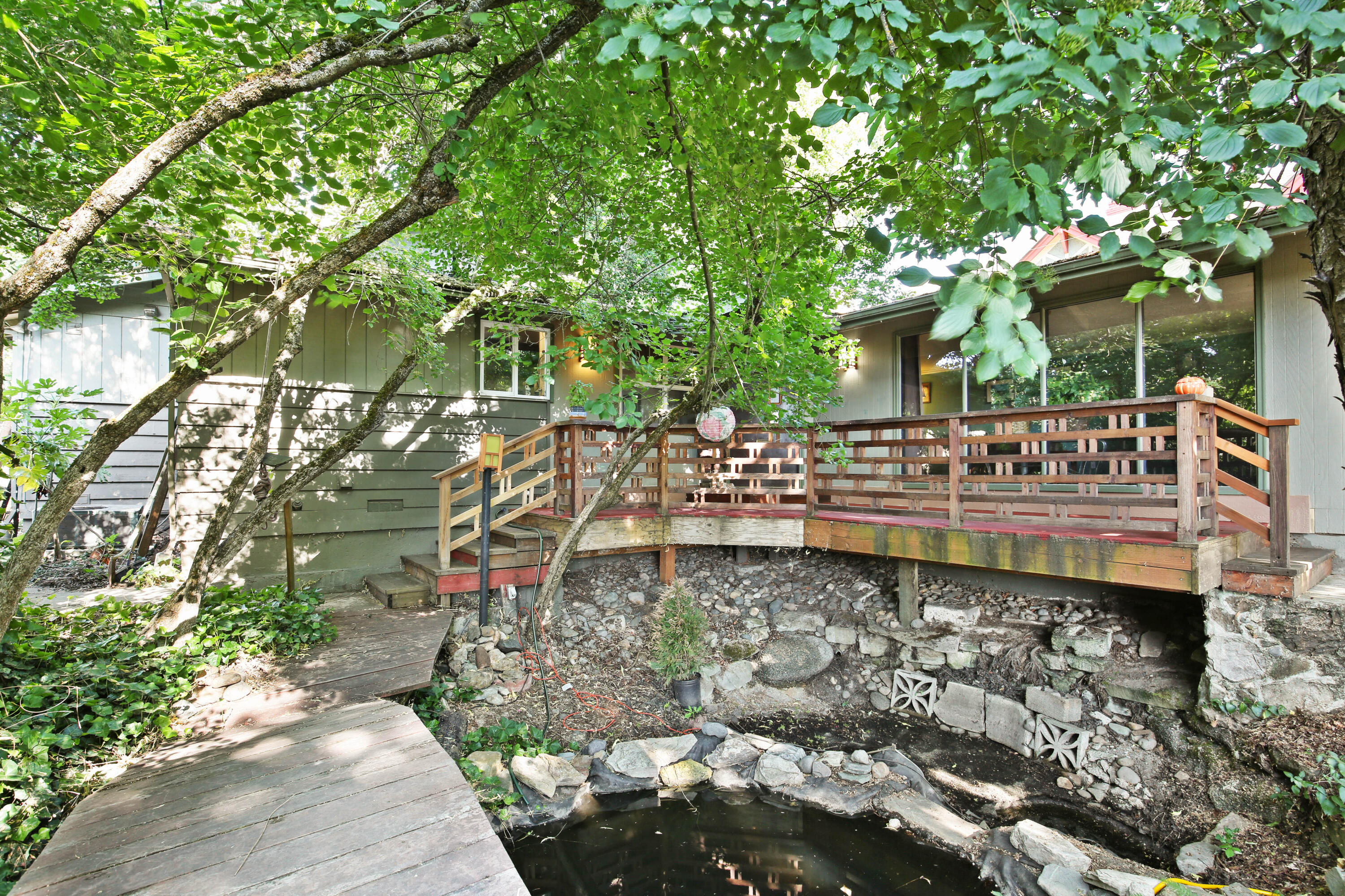 Discover this charming 4-bedroom, 2.5-bath home in a prime Medford location—just minutes from schools and the Rogue Valley Country Club (yes, even golf cart distance!). Thoughtful craftsman details, abundant natural light, and skylights bring warmth and character throughout. Enjoy the peaceful koi pond, water feature, mature shade trees, and fully fenced yard with alley access and RV parking.