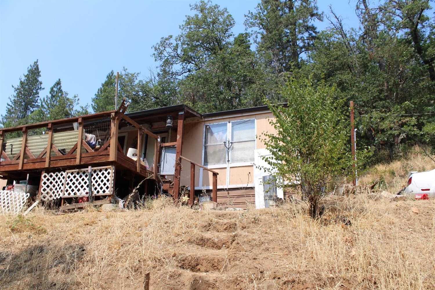 One-acre of land, with a 2 bed/2 bath, 1034 sq/ft-1984 double-wide manufactured home. Property has, sewer, well and power. Home is of little value, but could be brought back to life, value is in the land. Please do not drive up the driveway with out an appointment to view. Sold 'as-is where-is'. All information deemed accurate, but not verified. Buyer to do own due diligence.