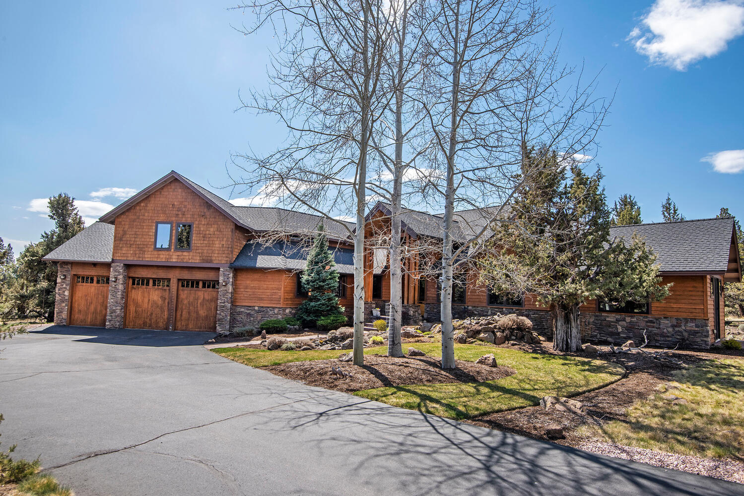 Exquisite Northwest Lodge style home in Aspen Lakes. Located on the 5th hole of the golf course with Cascade Mountain views from the covered main patio, dining room and master bedroom and bedroom patio. Great attention to detail in all aspects. Interior features: 2 Master Suites downstairs; large gourmet kitchen; high end stainless appliances; open floor plan; hickory wood floors; high vaulted ceilings; large wall of windows allowing for natural light; oversized laundry/mud room; freshly repainted walls; unusual amount of storage; unique custom Juniper fireplace mantle; new heat pumps and furnaces with a new separate heat zone. Exterior features: large covered patio; native and custom landscaping; new irrigation systems; freshly stained siding; prominent front and back water features. Home also has a 5 car garage with tall ceilings and oversize doors (3 bays widthwise and 2 tandem bays) to accommodate RV's, boats and toys. This elegant home is fully updated and move-in ready.