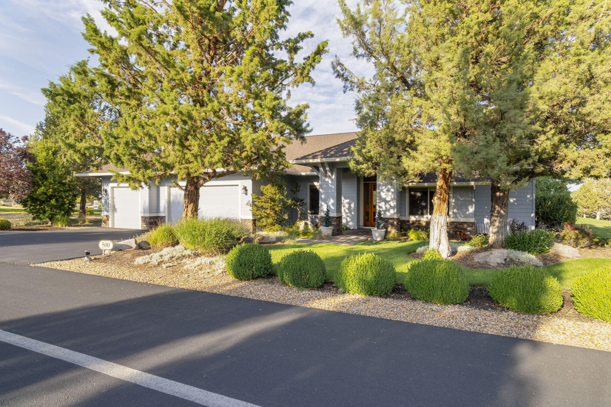 This beautiful, single story home is immaculate! Featuring many high quality features throughout, like travertine countertops, sturdy maple hardwood floors, and a heated three-car garage. The open great room floor plan includes a large dining room, built in cabinetry, fireplace and floor to ceiling windows. The kitchen has stainless steel appliances, custom wood cabinets with easy slide-out shelves, large island and fantastic views of the golf course. Each room has its own heating and cooling settings for comfort. Recent updates include a new Whirlpool dishwasher and microwave. Outside, there's a large patio with incredible golf course views and a Pergola that's perfect for relaxing or entertaining. This gorgeous home is located in The Falls, a 55+ community with its own clubhouse and access to all the amenities at Eagle Crest. It's move-in ready and feels brand new!