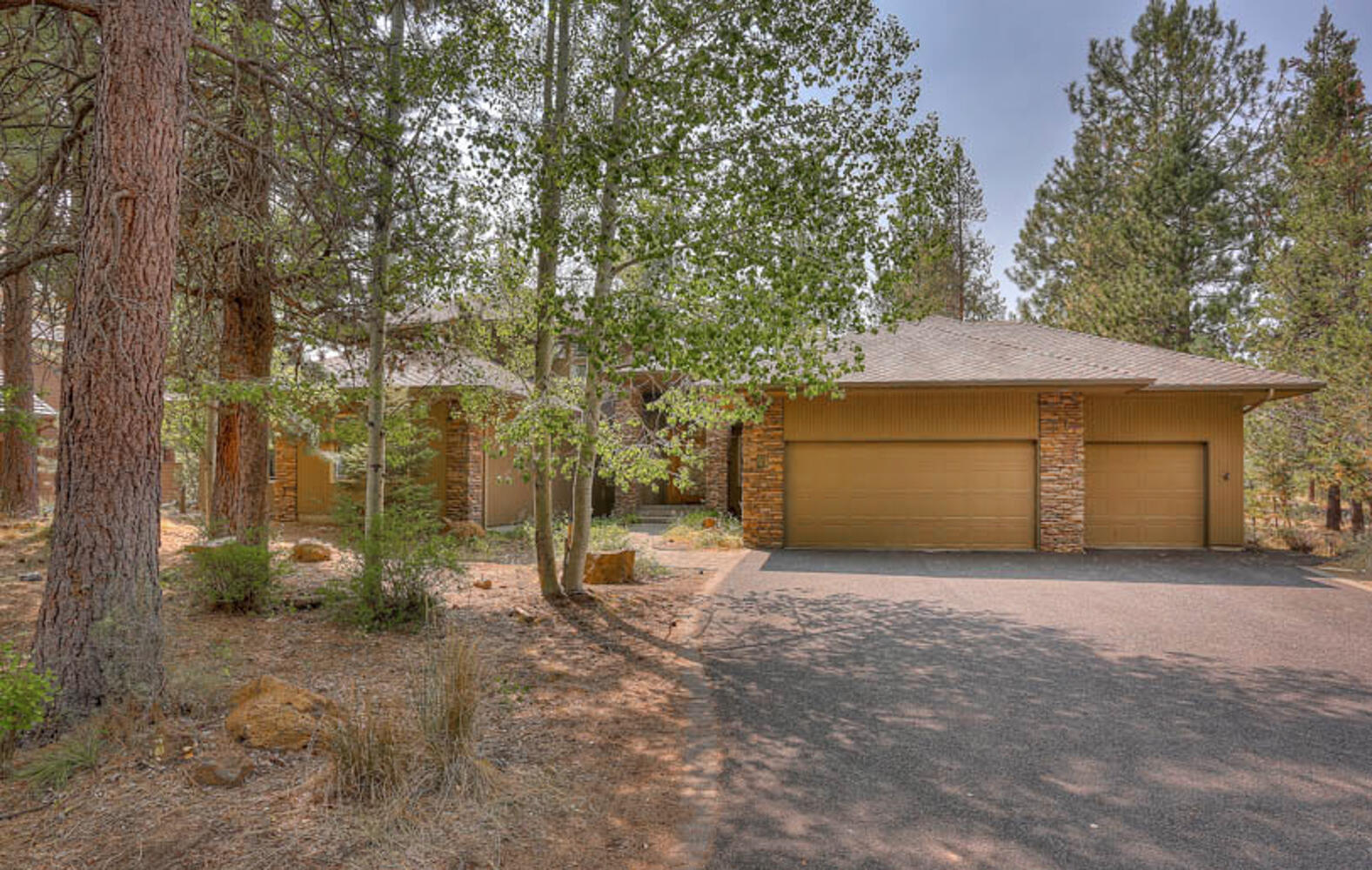 Gorgeous High-End Sunriver Vacation Rental 6Bd/4.5Ba! This exceptional quality built North End home w/stone fascia & clear cedar siding, paver walkway, 3 full suites w/private bathrooms (primary on main level), great room w/gas FP & new wood-lam flooring, 2-dining areas, bunkroom, huge-separate family/rec/6th bedroom w/bunk bed & closet, updated kitchen w/slab granite, center island & SS appl, large laundry/mud room to attached/insulated 3-car garage w/private lockable bay for owner lock up storage, low maintenance nature scape landscaping & paver patio w/hot tub, excellent SR north-west location across the street from 1000's of acres of Forest Land, a Proven Nightly-Rental with a high gross-income track record!