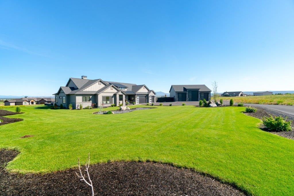 Big Cascade Mountain views serve as the perfect backdrop for this custom 2550 sq.ft. Modern Farmhouse built by Pahlisch Select on 5.08 acres. The open floor plan features beautiful custom beams, stonework & cabinets, floor to ceiling stone fireplace, a gourmet kitchen w/oversized island w/bar seating & a walk-in hidden pantry. A luxurious primary bedroom boasts a tiled SPA shower, Kohler jetted tub & double sinks. The flex room offers many options for its use. 1800 sq.ft. of glorious outdoor living with built-in BBQ, firepit & hot tub offers the perfect place to relax or entertain. Attached 3 car garage, 1584 sq.ft. heated 3 bay shop with pull through doors, RV hookup/pad & manicured landscaping are the icing on the cake. A wonderful functional plan with high end features both inside and out!