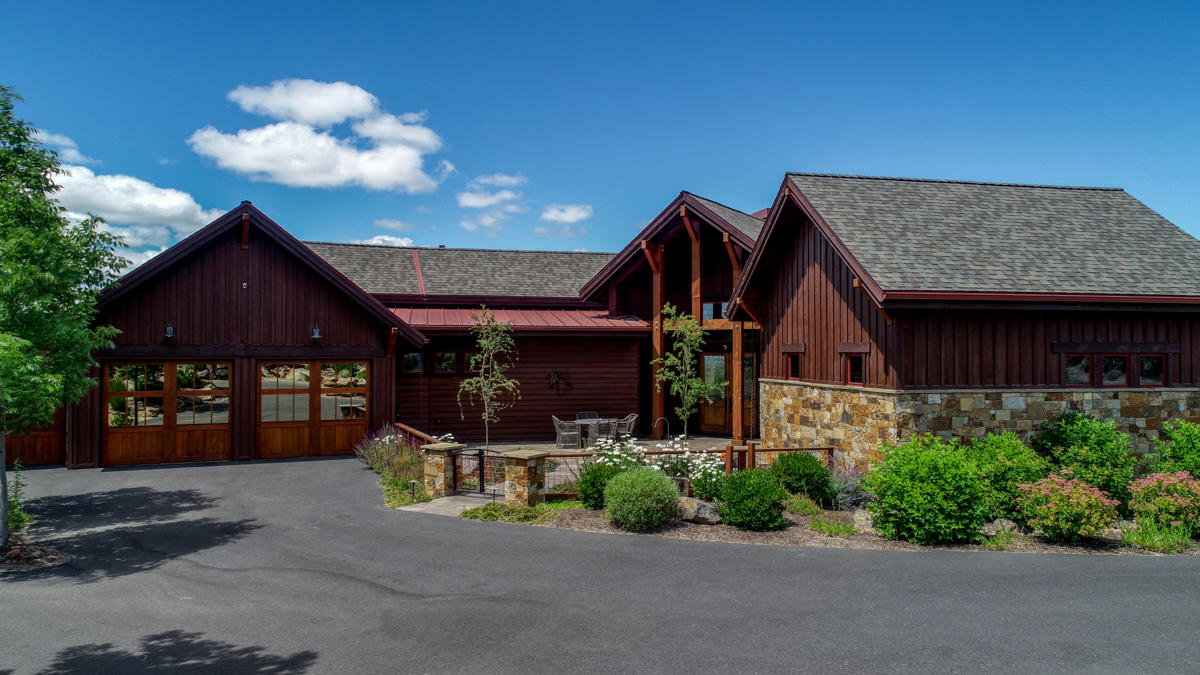 This beautiful one-level home is an entertainer's dream come true. As you walk into the foyer, you are greeted by a large great room with vaulted ceilings featuring gorgeous 19th century wood beams, English Oak hardwood floors and a floor to ceiling stone hearth fireplace. The Chef's kitchen has granite countertops, two islands, beautiful wood cabinetry, GE Monogram stainless steel appliances and a large walk in pantry. The large westerly facing windows in the great room area show off the gorgeous Cascade Mountain views. Heading out to the patio that wraps around the back side of the home and features several sitting areas, an outdoor BBQ kitchen, one can imagine the stunning sunsets to be enjoyed. The stunning landscaping adds to the outdoor living space. The master suite proves to be a quiet oasis with a large spacious walk-in closet, two separate vanities in the bathroom and lovely glass shower. Your guests will enjoy their privacy in their en suite quarters on the opposite side of