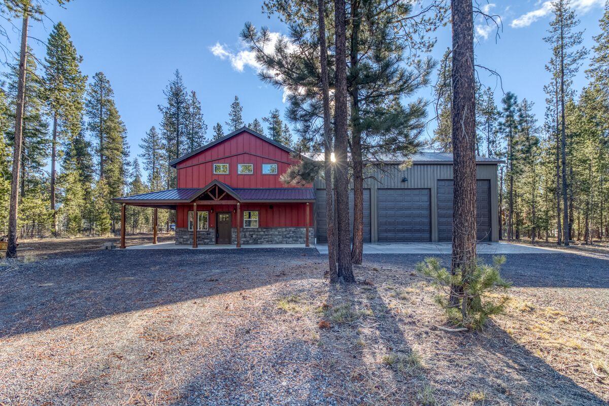 Discover the Modern Homestead Dream in this brand-new, desirable barndominium on a nearly 1.5-acre lot. This efficient, open-concept home features a well-appointed kitchen, large loft, and two full baths, all kept comfortable by a heat pump and electric fireplace. The exterior boasts a metal roof and expansive porches for private wildlife viewing and outdoor cooking. A true highlight is the oversized 3+ car shop/garage with workbenches—perfect for all your cars, trucks, and toys. With a private well and ATT septic, this turn-key property is an exclusive sanctuary for full-time living or a weekend escape.