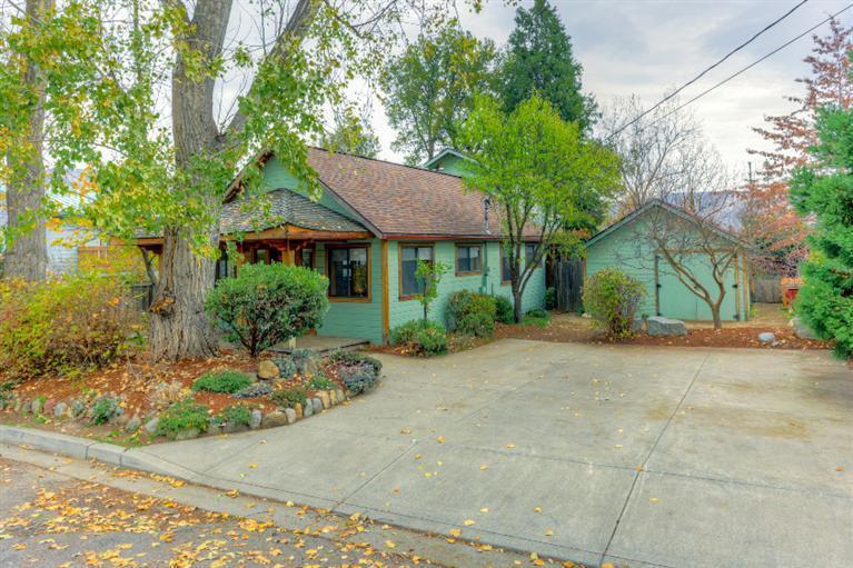 Wonderfully crafted home in prime Railroad District location. Inviting front porch with swing leads into a beautifully crafted interior. Local woods have been used extensively throughout the home and provide incredible warmth and character. Western maple and claro walnut abound in the home as seen in paneling, trim, banister and custom cabinets. True craftsman details can be appreciated throughout this three bedroom two bath home. R-3 zoning and the flexible floor plan provides the potential for partitioning the house into two separate units with separate heating systems & hot water heaters. The private yard has raised garden beds, compost bins, a separate detached sauna as well as a spacious shop with shelving. This is a beautiful, unique and rare property that must visited in order to fully appreciate!