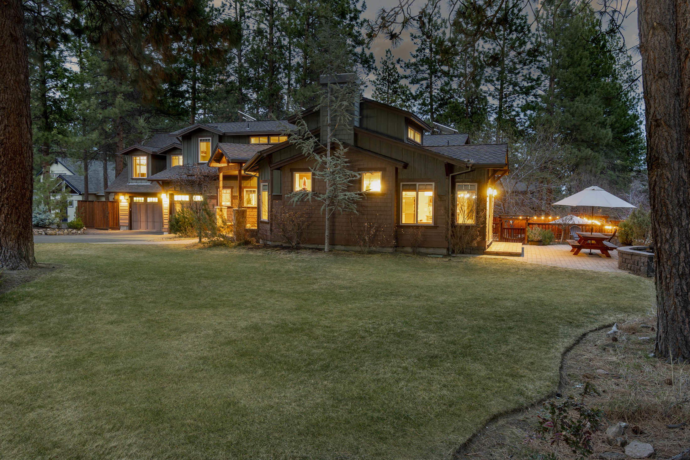 Gorgeous NW Design home nestled on private .40-acre park-like setting right in the heart of Bend's Westside. 1 bed/1 bath separate guest suite & RV parking!! Casual modern design blends harmoniously w/ touches of craftsman architecture, providing charm & character throughout.  Airy open spaces invite the beauty of landscaped yard inside w/ views from nearly every room. Spacious great room featuring soaring ceilings, cozy fireplace w/ bookcase surround, dining area that opens onto one of several paver patios & the cheerful kitchen welcome you home. Multiple private & peaceful spaces, inc. library w/ floor to ceiling bookcases, reading nook, family room, classroom/office w/ built-ins, fireplace & access to outdoor patios. Owner's suite w/ large walk-in closet, bath w/ bubble-jet tub & outdoor balcony overlooking beautiful yard. 4 addtl. guest rooms, one of which overlooks library & makes ideal addtl. office/study. Magical fenced back yard is home to amazing 2-story treehouse in the pines