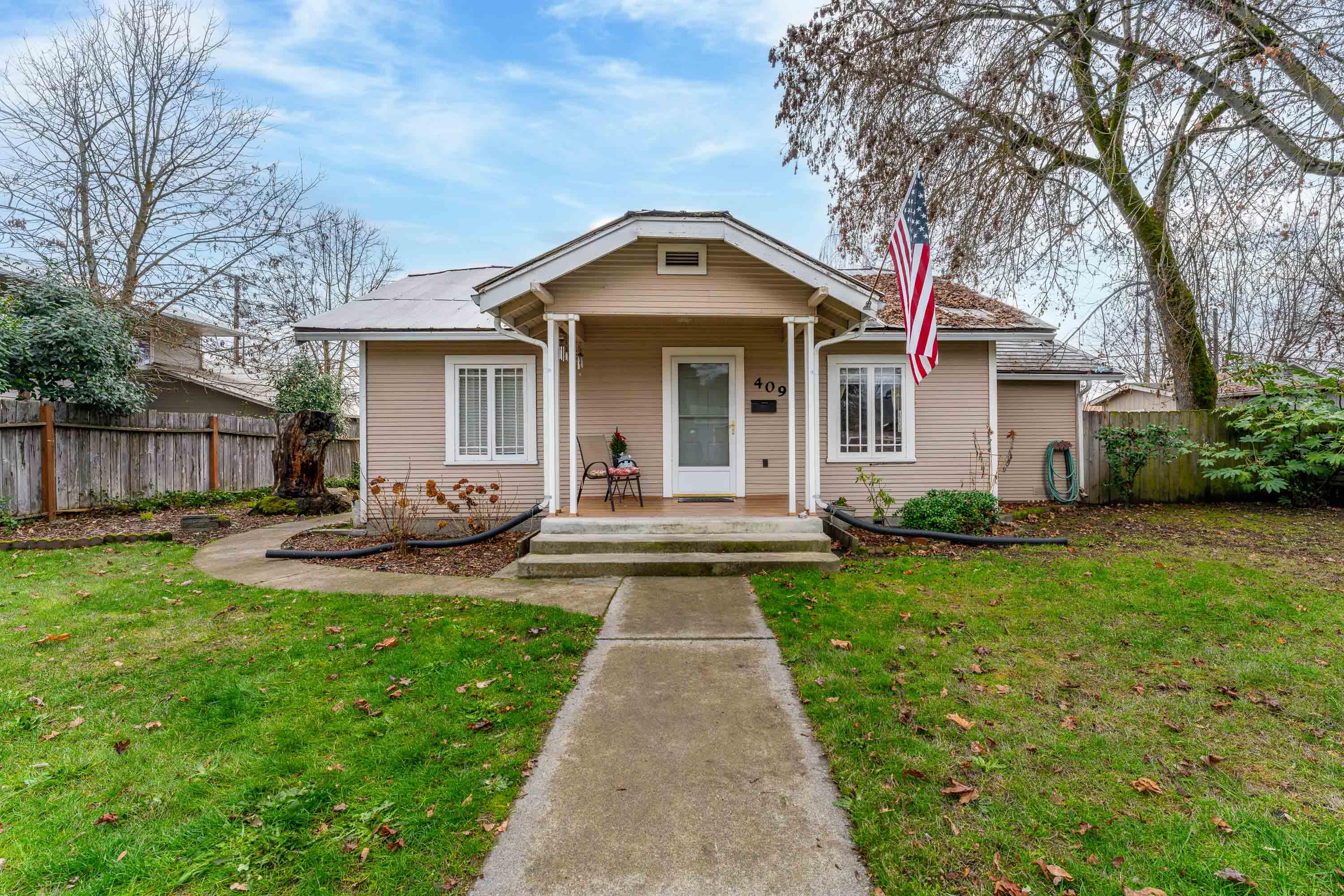 Charming 2 bedroom, 1 bathroom home in the heart of Grants Pass! The unique character honestly makes the home stand out. This home would make for a wonderful starter home or investment property! Enjoy the spacious, fully fenced yard and detached garage with alley access. Large back yard patio with sidewalks to garage and alley parking. The property is zoned R-4. convenient to shopping, restaurants, and more. All information is deemed reliable. It is suggested that any one considering the purchase of the property, perform due diligence regarding the uses and condition of the subject property