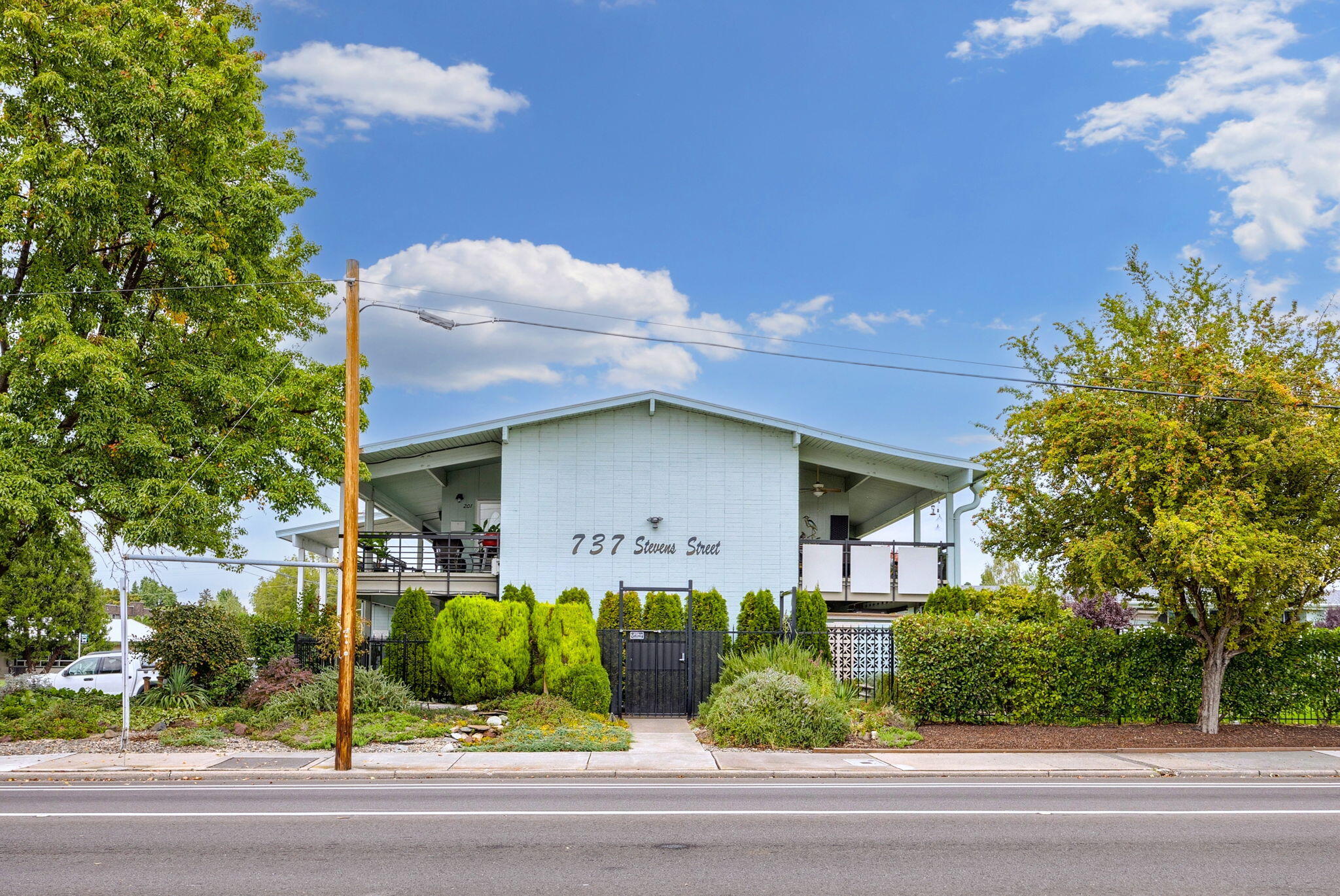 Ground Level Unit in this 55+ Co-op gated community! All units are owner-occupied only! Hawthorn Gardens lives up to its name with beautiful gardens surrounding the heated pool, clubhouse and picnic area offering full use of the cabana and gas BBQ. This community is close to the Medford Village shopping, dining choices, outdoor growers' market, entertainment, medical services, banks and public transportation. This co-op complex is situated on a 3.14-acre private park-like setting with security gate and cameras. Plenty of built-in storage, plus closets & pantry as well as detached onsite storage, laundry facilities, and assigned carports. Monthly association fees of $208 include the property taxes, insurance, water, sewer, trash, lawn care, pool, and on-site laundry facility. Sliding glass doors open from the living room and one of the bedrooms to a personal covered patio looking out to lovely, manicured grounds.