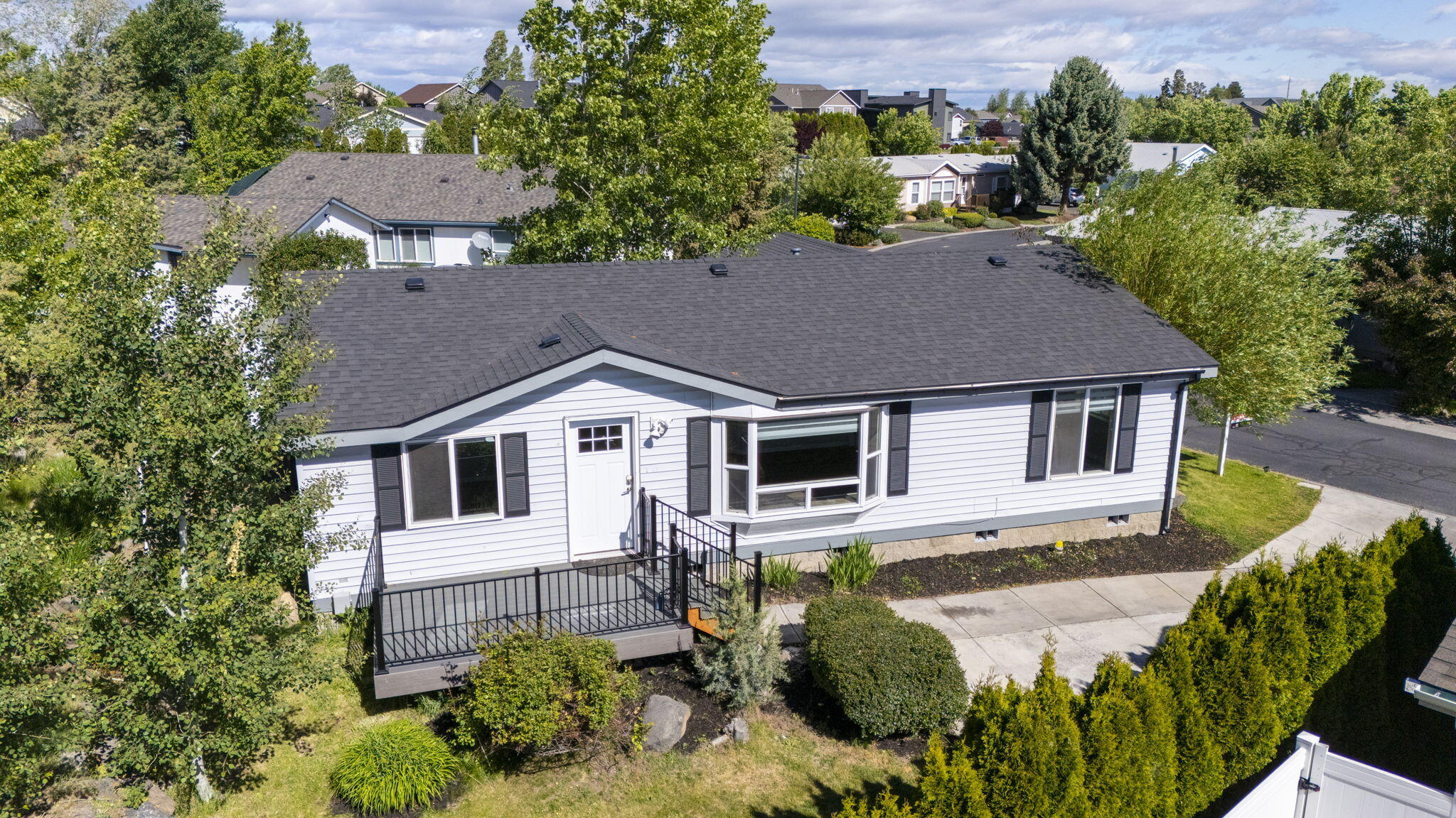 Don't miss this completely refreshed home on a terraced lot. Fully updated just two years ago & turn key ready for new owners! 3 bedroom 2 bath home w/new roof, paint, doors, floors, trim, skylights, cabinets, granite counters & much more. Open layout w/large living area featuring vaulted ceilings, large windows & luxury vinyl plank throughout living spaces. Breakfast bar seating in the open kitchen area, stainless steel appliances included, modern backsplash & hardware + tons of natural lighting. Eating area is spacious w/large sliding glass doors to the back deck. Primary bedroom is spacious w/primary bath featuring dual sinks in vanity & a walk in custom California Closet pack. Two additional bedrooms at the opposite end of the house share a full bath. Laundry room features built in storage & exit to the attached dbl garage. Forced air heat w/AC. Move in ready!! New Trex deck, modern iron rails, custom blinds & Brand new SS dishwasher!