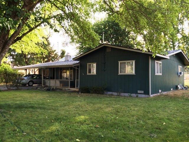 Great Mini Farm Potential! Here's a great property on the edge of town with 2.29 acres with irrigated pasture. Solid little house just need some TLC. Features 3 bedrooms. 1 bath, approx. 1198sf, there's a bonus room attached by a breezeway that has it's own wall HP, and a large shop, country setting just on edge of town.