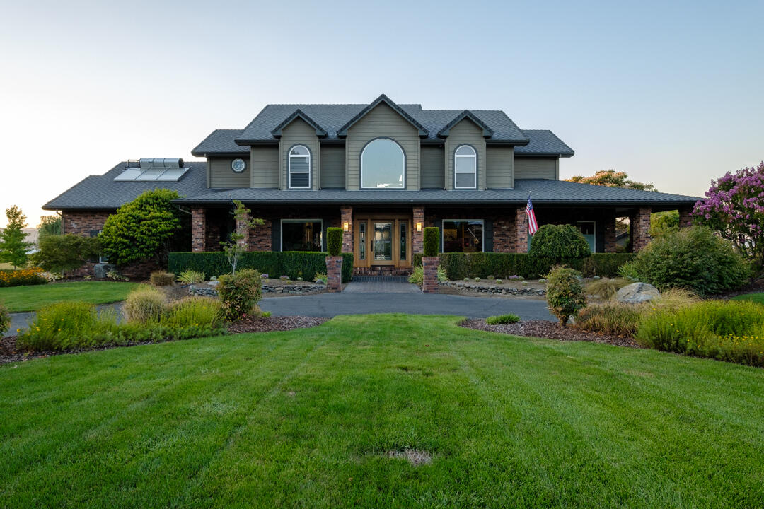 This unique property with unbeatable views, in a park-like setting features an elegant Pacific Northwest style home, remodeled and professionally decorated in 2015, including solid walnut cabinets in a chef designed kitchen, with Wolf, Bosch and SubZero appliances, trash compactor, walk-in pantry, prep sink, pull out cabinets, and copper hood.

The great room features a soaring rock fireplace, built in TV cabinet with surround-sound, automated blinds. The dining room, with double french doors, and built-in bar easily seats 8. With built-in book shelves and a view of the circle driveway the formal living room is a perfect sanctuary. The downstairs master suite features plentiful closets, extra large steam shower and dry sauna.

Upstairs includes 1 ensuite bedroom; 2 bedrooms sharing a Jack and Jill bath, all with walk in closets; an office with generous built in cabinetry.

With a healthy well and irrigation rights, on flat land near town, this property is a rare find.