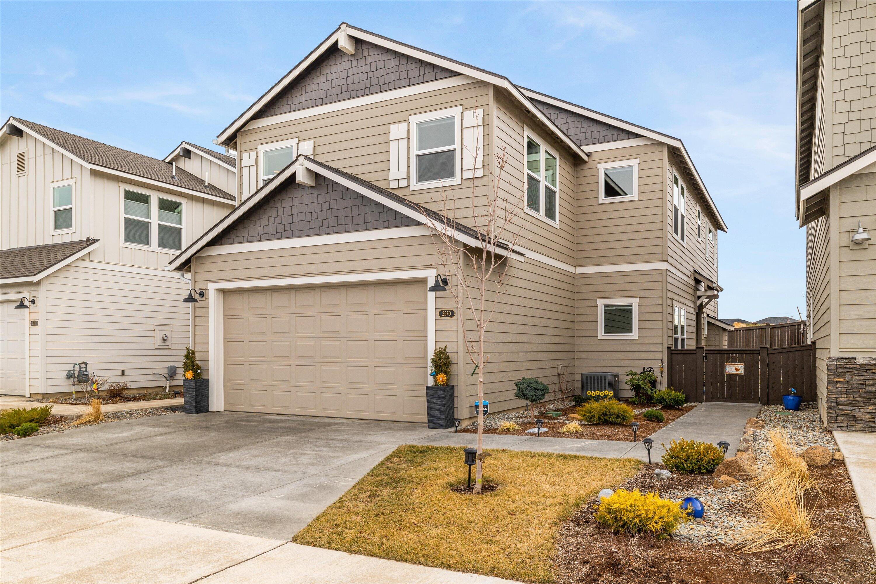 This beautiful 4 bedroom, 3 full bath home built in 2021 is a perfect blend of luxury and comfort. Located in NW Redmond in reach of neighborhood parks, Dry Canyon & more! Spacious floor plan with a primary bedroom on the main & on the 2nd floor! 9 ft ceilings on the 1st floor offers a large great room featuring a cozy fireplace. Upscale kitchen features Quartz counter-tops, a full height backsplash, large island, pantry and stainless steel appliances. Upstairs primary suite boasts a double vanity, walk-in closest, and step in shower. Looking for extra space? Look no further than the huge second-floor loft, which can be used as a game room or media room. With plenty of room to spread out, this home is ideal for families of all sizes. Low maintenance backyard is fully fenced with a covered patio, water feature and pavers throughout - perfect for enjoying year around. Custom blinds throughout, A/C, Tankless water heater & no HOA!