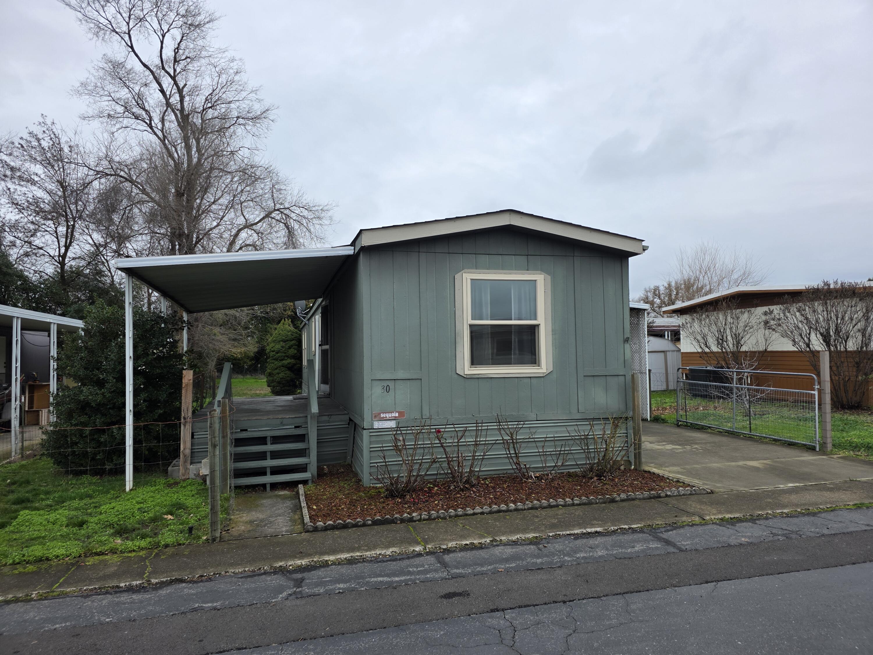 Welcome home to Greenbriar Terrace, a desirable 55+ mobile home community offering comfort, convenience, and great amenities. This well-designed floor plan features a vaulted living room open to the kitchen, creating a bright and airy living space. The spacious primary bedroom features a walk-in closet, and the second bedroom is well-sized with ample closet space, perfect for guests or a home office. Enjoy a large kitchen with dining area, plus a separate laundry room with direct access to the outdoors. Outside you'll find gated parking under the carport, two storage sheds, and a good-sized backyard—perfect for relaxing or gardening. Recent upgrades include new carpet and vinyl flooring, ductless A/C installed in 2020, upgraded insulation, double-pane vinyl windows, and a newer composition roof. The community features a clubhouse with fitness room, pool tables, kitchen, and a seasonal swimming pool. A wonderful opportunity for active and social lifestyle!