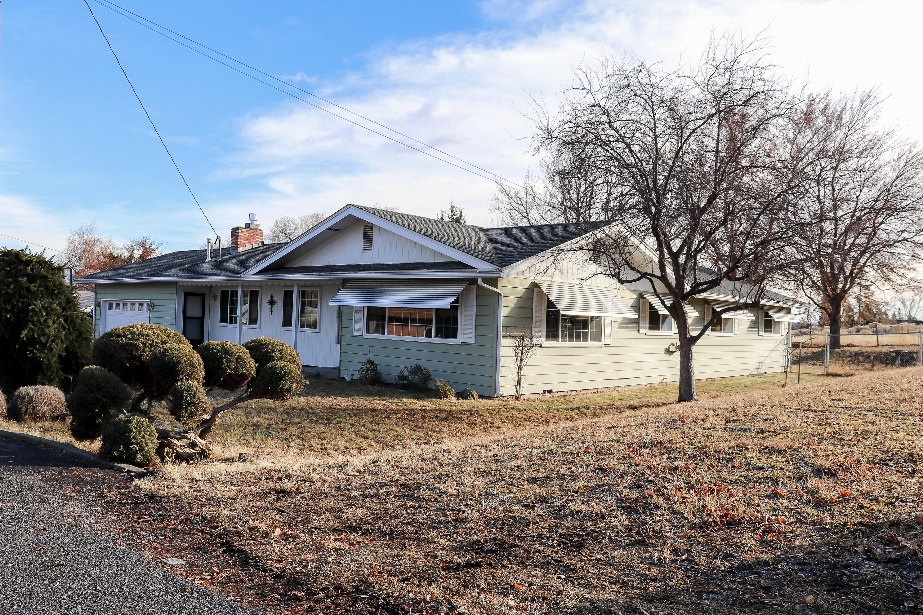 Close to town with a country feel! Loved and meticulously cared for by only two owners, this comfortable home is nestled in the well established neighborhood of West Hills. The property backs up to pasture and has no homes behind it! Mature trees and shrubs adorn this lot, creating a serene and inviting space to enjoy the outdoors. Welcome to this nearly 1900 square feet, 3 bedroom, 2 bathroom home featuring two living spaces (living room and den) which provide an abundance of usable space! The walkthrough galley kitchen has plenty of storage and an eat in bar that opens up to the dining  room.  Make yourself at home and  curl up next to the living room's natural gas fire place or escape to the massive master bedroom (with space for an at home office!). Yes, this home is move-in ready! Yes, there is an attached double garage! Yes, it is the one you have been waiting for! Call for your personal your today!