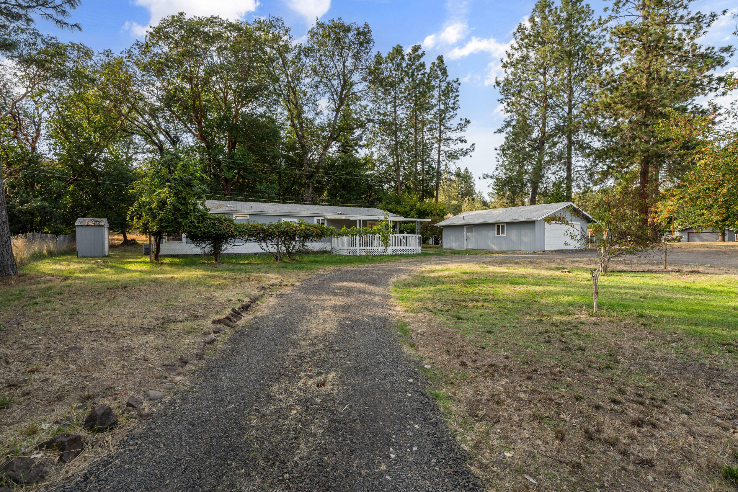 Beautifully remodeled and move-in ready, this Shady Cove gem at 250 Madrone Ln offers comfort, character, and functionality in one complete package. Set on a solid concrete block foundation, this home features a bright, open layout with updated flooring and modern finishes throughout. The kitchen is fully equipped with brand new stainless steel appliances including a new oven, microwave, and refrigerator, perfect for everyday living or entertaining.
Enjoy the convenience of city sewer, a well, and a double deep 2 car garage that includes its own bathroom, ideal for workshop use or extra storage. The spacious lot offers privacy at the back, plus a charming historic barn and several useful outbuildings and sheds. Located in a quiet neighborhood just minutes from the Rogue River, local amenities, and outdoor recreation. A perfect fit for buyers seeking value, updates, and space to spread out.