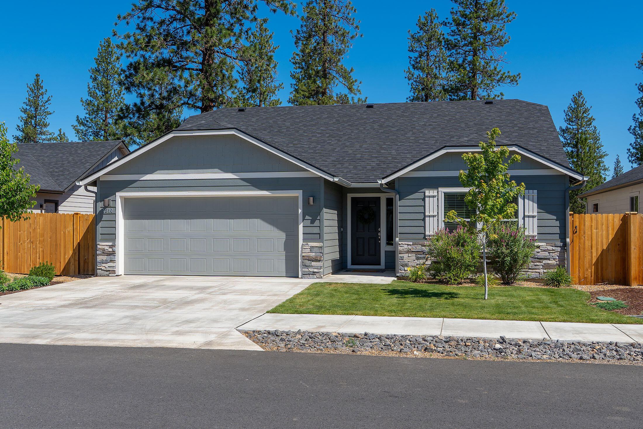 Enjoy the sense of privacy this home offers, backing up to private, tree-filled land. Inside, you'll find thoughtful upgrades including white cabinetry, quartz kitchen countertops, and high-end laminate plank flooring throughout the great room, kitchen, and dining area.

At 1,408 square feet, this home proves that a mid-sized home can still feel spacious and refined. Vaulted ceilings enhance both the dining area and the generous living room, while the open-concept kitchen creates an inviting space for gathering and entertaining.

Located in McKenzie Meadows Village this home is within walking distance to top-ranked schools and world-class recreation.