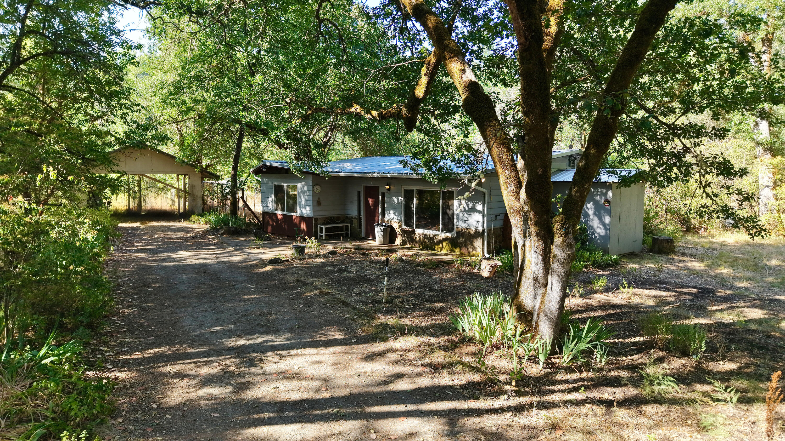 Back on market- No fault to seller. MOTIVATED SELLER. Looking for the perfect blend of farm life, rural charm, and an updated cabin? 

This inviting 2-bedroom, 1-bath home sits on over 12.36 acres of usable land, offering endless potential for homesteading, horses, or simply soaking in the peace and quiet of country living.
The property includes a garden area, carport, shop, horse stalls, and a horse arena—everything you need to create your ideal rural lifestyle. In the spring, the land comes alive with vibrant flowers, mature trees, and visits from local wildlife, making it a true nature lover's retreat.
Recent upgrades include a new roof, new back patio, enclosed wood shed, new gutters and downspouts, a new certified wood-burning stove, and mini splits, bringing both comfort and efficiency to your country home. This gem is just waiting for someone to bring it fully back to life. Don't miss out on this unique opportunity to own your own slice of country paradise!