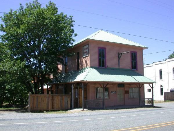 Huge Price Reduction! Historic (but not registered as such) commercial property with frontage on Hwy 199 (Redwood Hwy). Redwood Hwy runs between Grants Pass and Crescent City with many tourists traveling through. Over the years this building has been home to several businesses including the Kerby Post Office and Kauffman Wood Products. It is presumed to be the oldest building in the Illinois Valley. It sits across the street from the Old Stoney Front Tavern (now the G-Spot Bar and Grill) and the Kerbyville Museum. There is a ton of character, charm, and potential here not to mention space (2860 sq ft inside plus an unfinished basement with approximately 1716 sq ft). Possible Restaurant? Antique store? Large open spaces upstairs and down for retail display. Studio apartment in back, also the upstairs has a full bath and is plumbed and wired for a kitchen. Has a well in addition to city water. Owner may carry on an adjacent 0.17 acres. More historical data available upon request