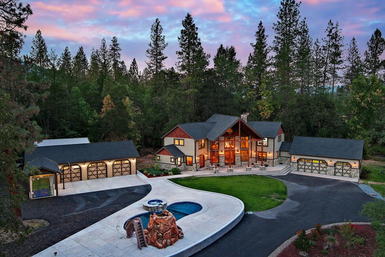 Tucked away in the heart of the World famous Applegate Wine Country, your Mini Estate awaits. Listed below tax assessed value for a quick sale. Have you ever dreamed of owning a home you never want to leave that offers the amenities of a 5-star resort? Well, look no further. This fully fenced and gated, almost 5 flat acre property has it all. Custom built 3239 sq ft home with 3 Primary Suites (one downstairs and 2 upstairs) that all have large walk-in closets and an office that could be used as a 4th Bedroom. Take in the incredible, ever changing views from every room. Great room with floor to ceiling rock fireplace and windows. Kitchen boasts a huge island, tons of storage and stainless appliances. Beautiful In-ground, heated saltwater pool with a waterfall, grotto, slide and a hot tub. 3 car attached Garage and an addition 3 car detached Shop, large Metal Carport for Boat/RV storage, Full RV Hook-ups, Batting cage, Dog Run, Garden, 2 Ponds and a season creek, Pasture and more.