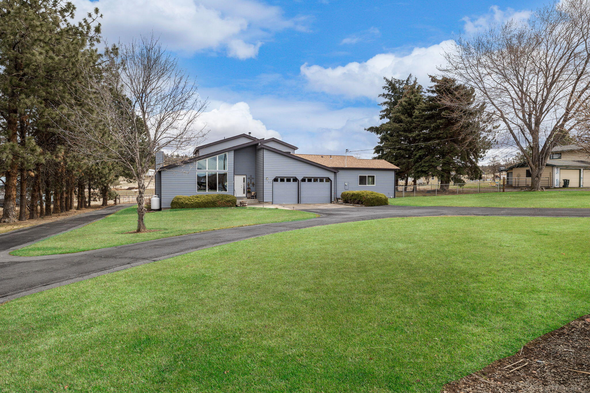 Pride of Ownership! Beautifully kept 4 bed/3.5 bath/2906 sq ft home in a long-standing neighborhood. Large entry w/vaulted ceilings leads into sitting room w/propane fireplace & large newly installed windows that allow you to enjoy your views of the Cascade Mountains. Office tucked away overlooking mature fully landscaped & fenced back/side yard.  Flexible floor plan offers the newly constructed addition of a main floor primary bedroom with on-suite bath offering a walk in shower & large walk in closet. Formal dining as well as breakfast nook, 1/2 bath, mud & laundry room on main floor. Living room w/wood burning fireplace, leads out to the large covered patio.  Lots of storage in the kitchen equipped with S/S appliances. Upstairs offers 2 additional spare bedrooms, hall bath includes large linen closet & dbl sinks. Large secondary primary suite with walk in closet & on suite bathroom. All sitting on 1.22 acres, w/attached dbl car garage, storage shed, storage building & shop w/lean to
