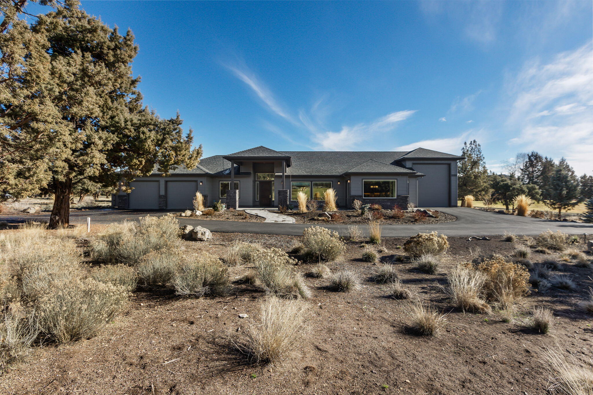 This outstanding single level home has it all:  Golf Course! Views! Gourmet Kitchen! Outdoor Living! 3 Large En-Suites! Heated RV Garage! 
Strategically located on the EC Ridge golf course, this custom home maximizes views of 14th fairway and the Buttes.  The kitchen is a cook's delight!  High-end Dacor appliances.   5-burner Gas cooktop with quiet high velocity hood, double ovens, microwave drawer, wine frig, and wet bar.  Huge walk-in pantry (with direct access from driveway for easy grocery unloading).   Entertain your family/friends in the large breakfast nook with golf/butte views, the formal dining room, or the 2 fenced paver patios (both with BBQ hookup). There is even a gas fire pit for S'mores nights! Three en-suite bedrooms with windows on two walls maximize views and natural light.   In addition to an oversize 2-car garage this home has a large, heated RV garage.   There's even something for your pup: his/her own door and fenced private lighted area!