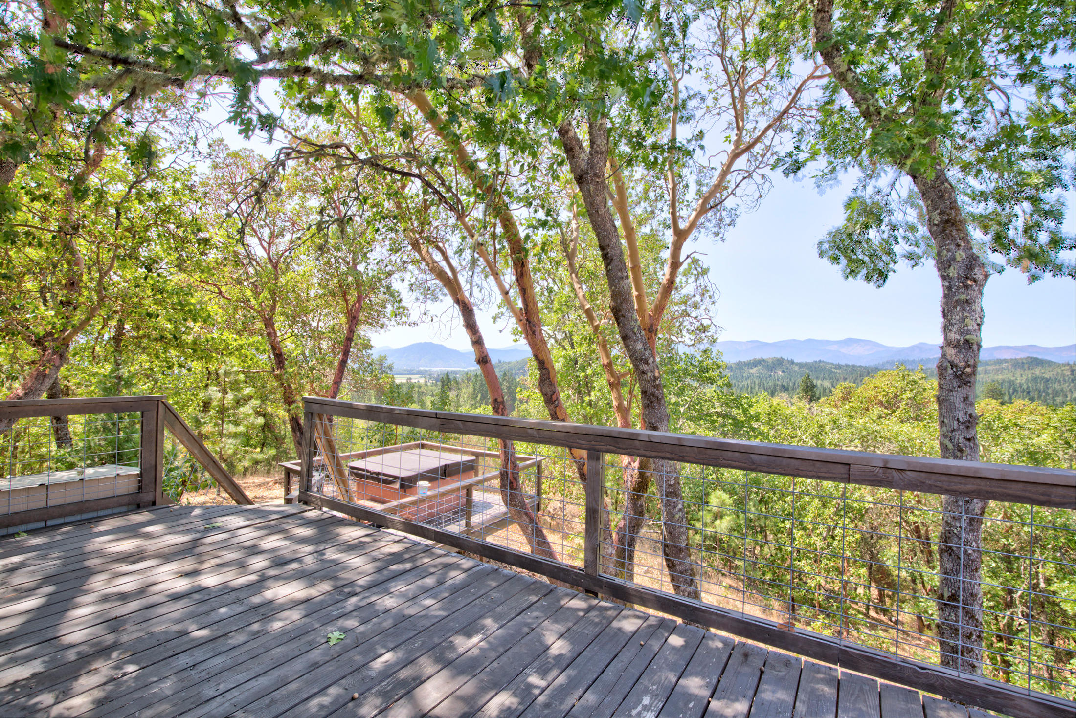 Absolutely breathtaking views and so many possibilities on this beautiful 5.95 acre property! Enjoy almost 40,000 square feet of Garden area with irrigation set up, water storage tank and electrical service. Spacious shop with approximately 800 square feet, is there for all your projects, as well as a shipping container for additional storage. Potential to subdivide with the RR2.5 zoning gives you another option for development. Live in the existing 1,200 sq ft, 3 Bedroom, 2 Bathroom manufactured home while you build your dream home or settle in and enjoy all the features this property already offers. With a wonderful mix of trees on sloping terrain, as well as level areas with usable space, there's something here for everyone. New deck with steps to the  hot tub allows you to relax and take in the gorgeous views after a long day. There's endless potential with this property so make your appointment to see it today!