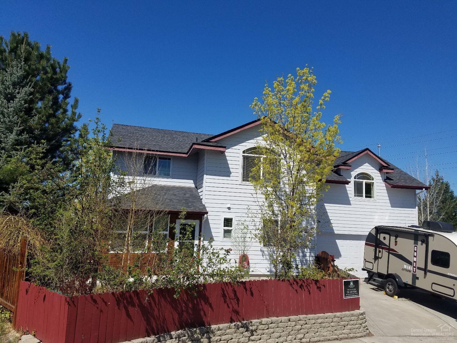 Set in a quiet cul-de-sac, this home is the definition of move in ready! Lovingly cared for - all new carpet and wood laminate flooring, new roof 2016, newer AC unit - just waiting for a new family! 3 upstairs bedrooms - including the master - and a 4th downstairs (also makes a great office). Huge upstairs family room with sink and mini-fridge. Lots of parking for your toys. Cascade views from 2 bedrooms - and Pilot Butte and the fireworks from the lushly landscaped backyard. And the hot tub is included!